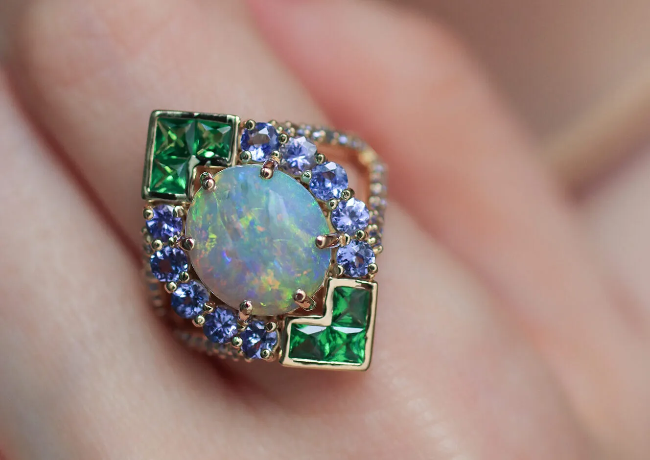Mariyeh Ghelichkhani Angels Fall ring with a round-shaped Australian opal cabochon, tsavorites and tanzanites set in 18k yellow gold 