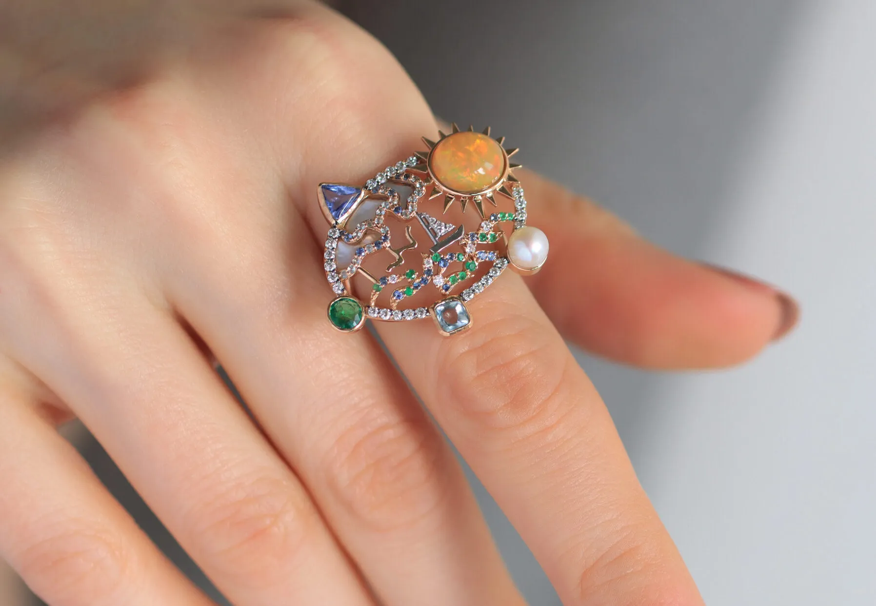 The Mariyeh Ghelichkhani Serene Voyage ring conjures an ocean scene with a precious opal, diamonds, coloured sapphires, emerald, mother of pearl and a single round pearl set in 18k yellow gold 