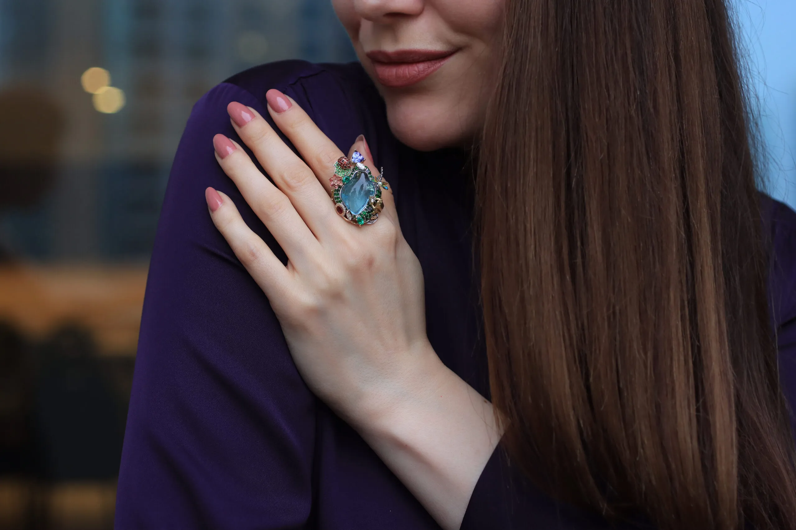 Katerina Perez wears the Hayat ring by Mariyeh Ghelichkhani with a 22-carat aquamarine surrounded by multi-coloured gemstones and diamonds in 18k gold 