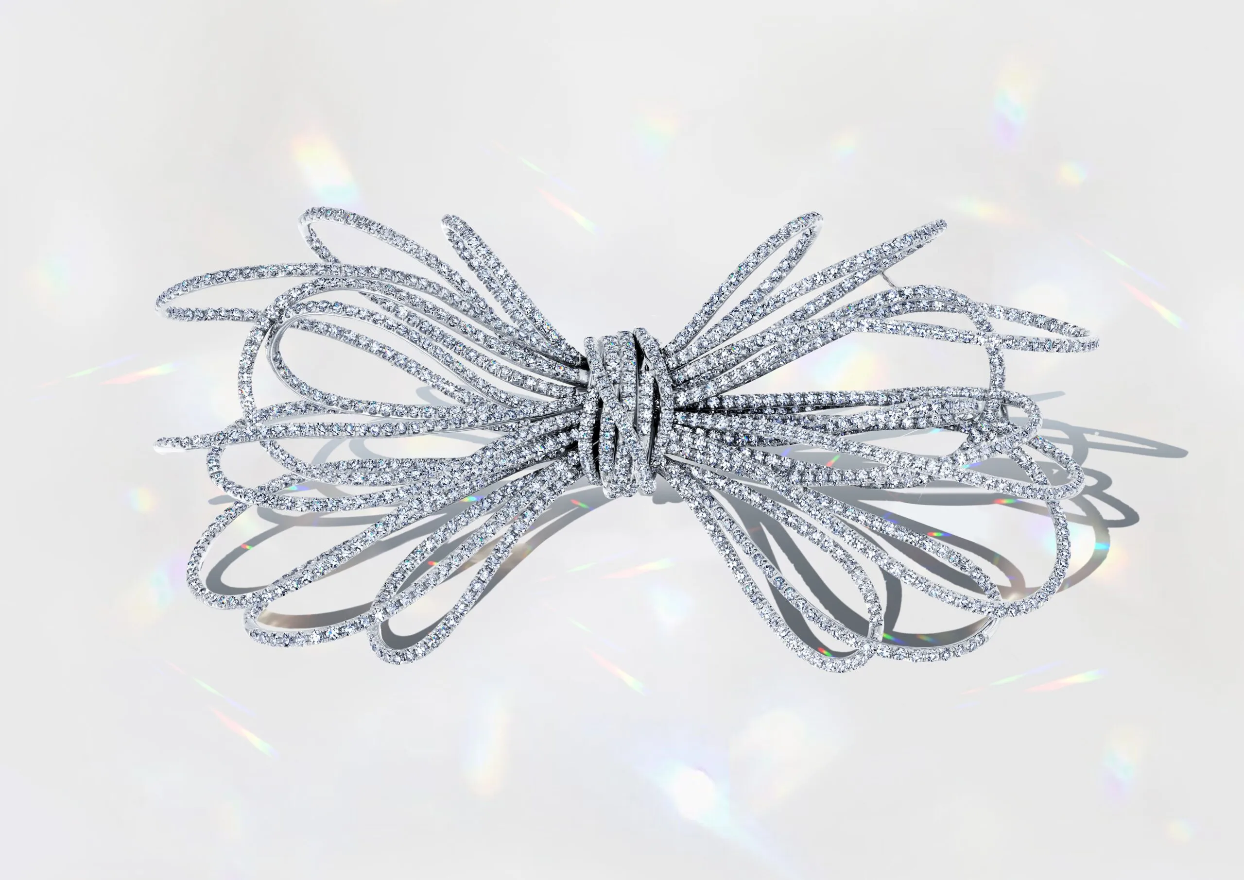 Martin Katz Anniversary Diamond Bow pin featuring 1,137 diamonds, weighing over 13 carats, inspired by the fluid lines of shredded paper ©martinkatzjewels