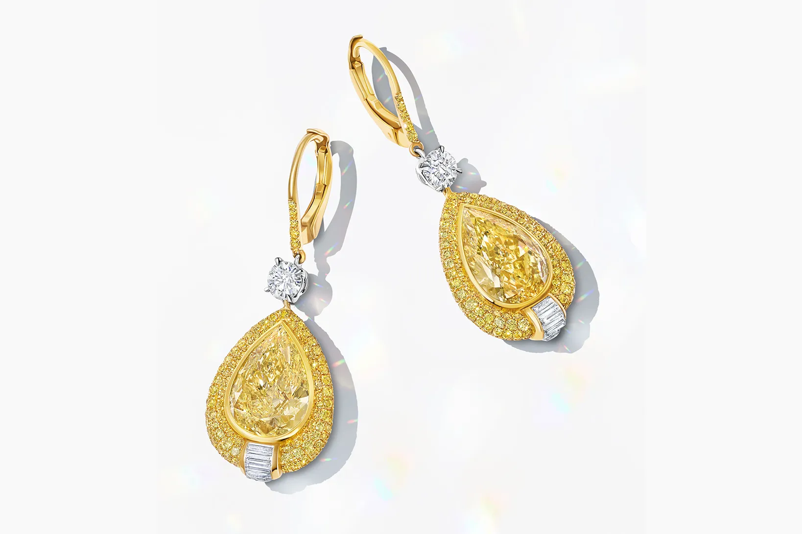 Martin Katz earrings with fancy yellow pear-shaped diamonds totalling 8 carats, accented with two round diamonds, 12 channel-set baguette diamonds, and micro-set with 404 fancy yellow diamonds, set in 18k yellow gold ©martinkatzjewels
