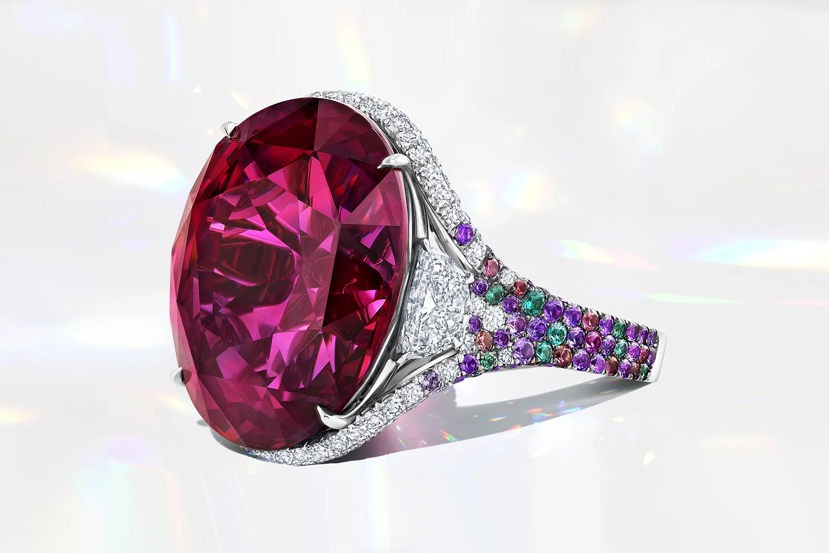 Martin Katz right-hand ring with a 33-carat unheated bluish pink oval-shaped sapphire, accented by two half-moon diamonds and 319 micro-set gemstones, including lavender sapphires, amethysts, and colour change garnets