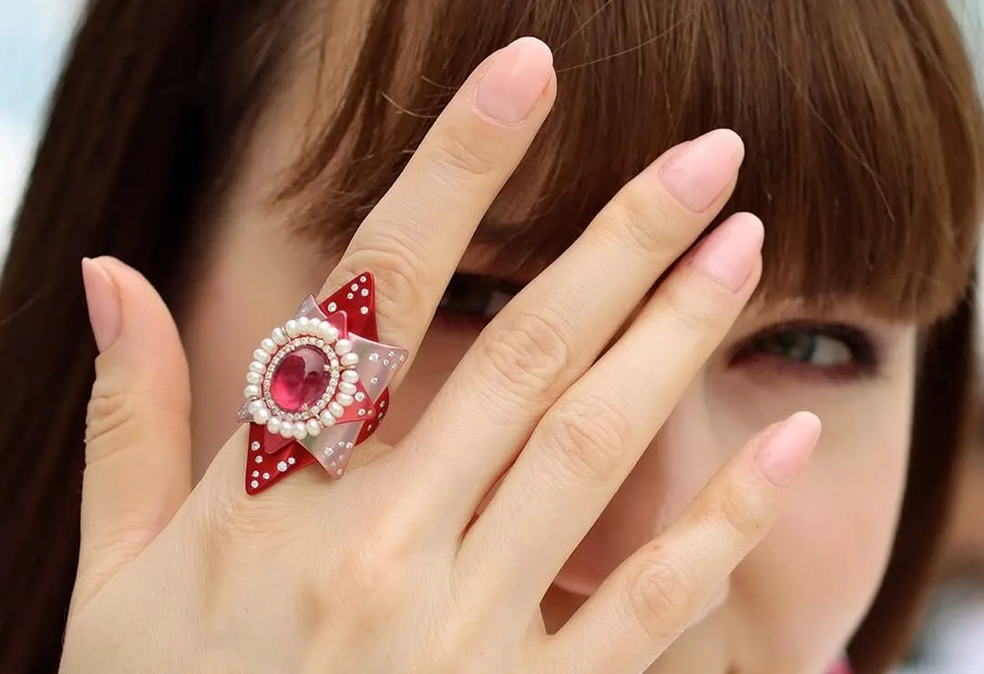 Katerina Perez wears the Mayiana MY Star ring inspired by the celestial beauty of the night sky with a 3.82 carat rubellite cabochon, 3.36 carats of pearls and further diamonds in 18k rose gold and pink and red aluminium