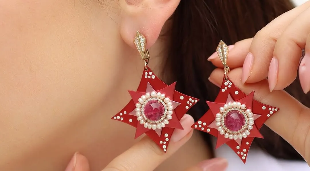 Katerina Perez wears the Mayiana MY Star earrings with two rubellite cabochons totalling 9.27 carats, 1.22 carats of diamonds and 6.16 carats of pearls set in 18k rose gold and pink and red aluminium 