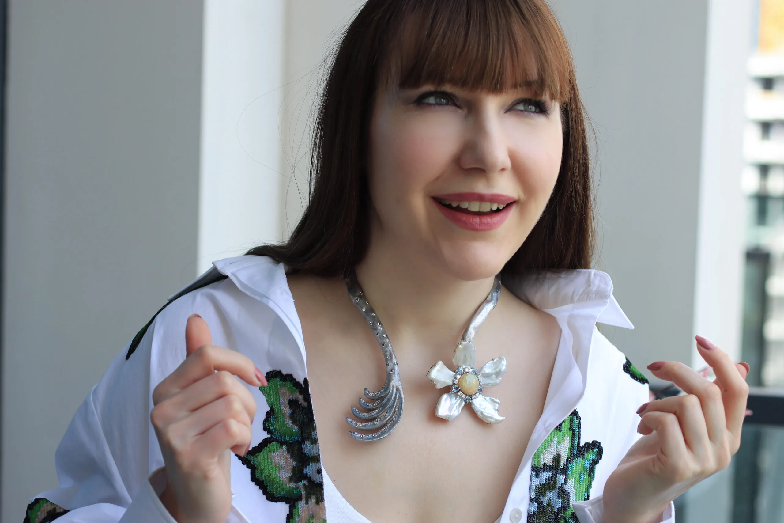 Katerina Perez wears a Mergin Jewelry by Mehragin Rahmati necklace with diamonds, aquamarine, opal and pearls 