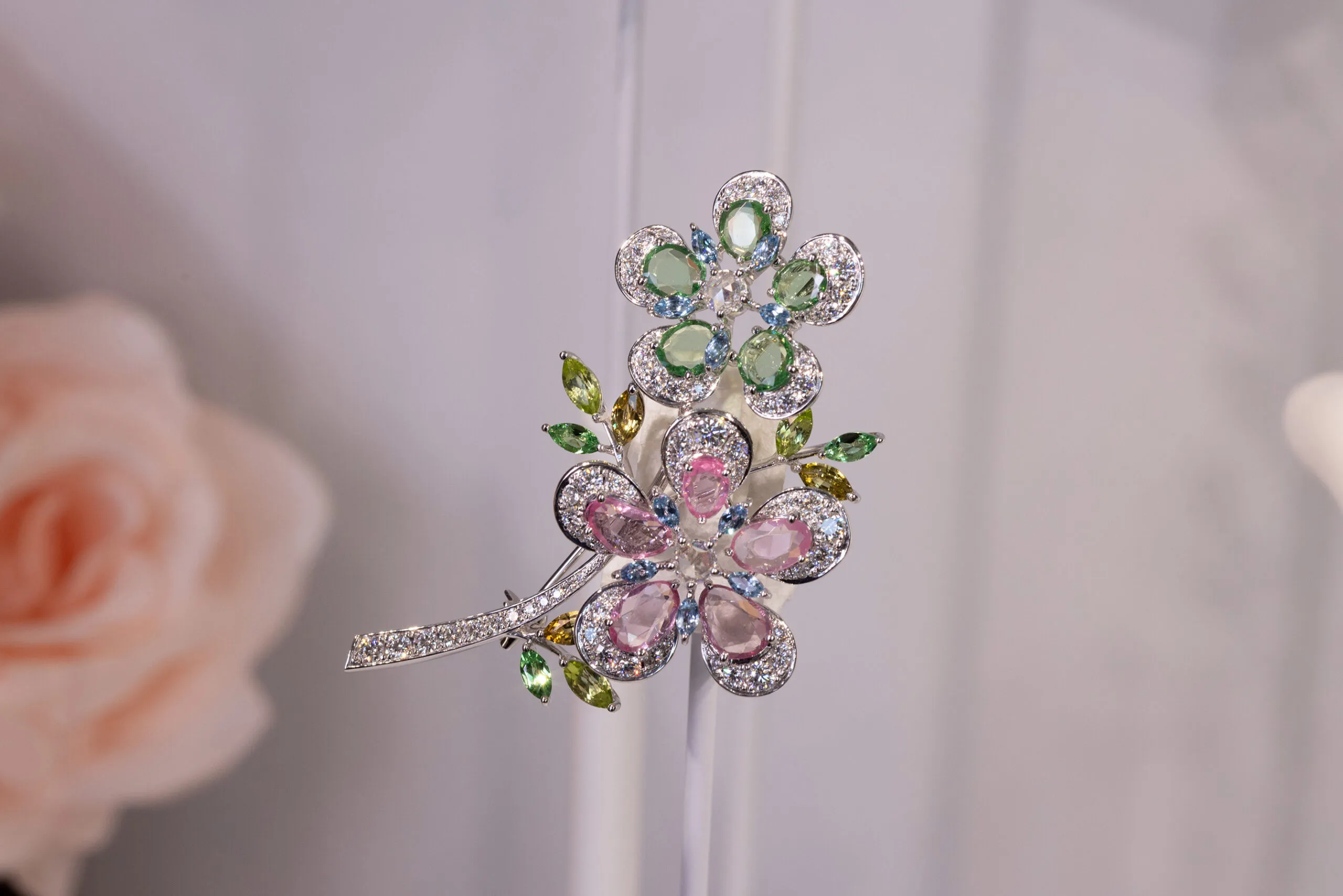 Mikimoto brooch with 2.59 carats of spinel, 2.14 carats of garnet, aquamarine, peridot, tourmaline, and 1.98 carats of diamond, set in 18k white gold 