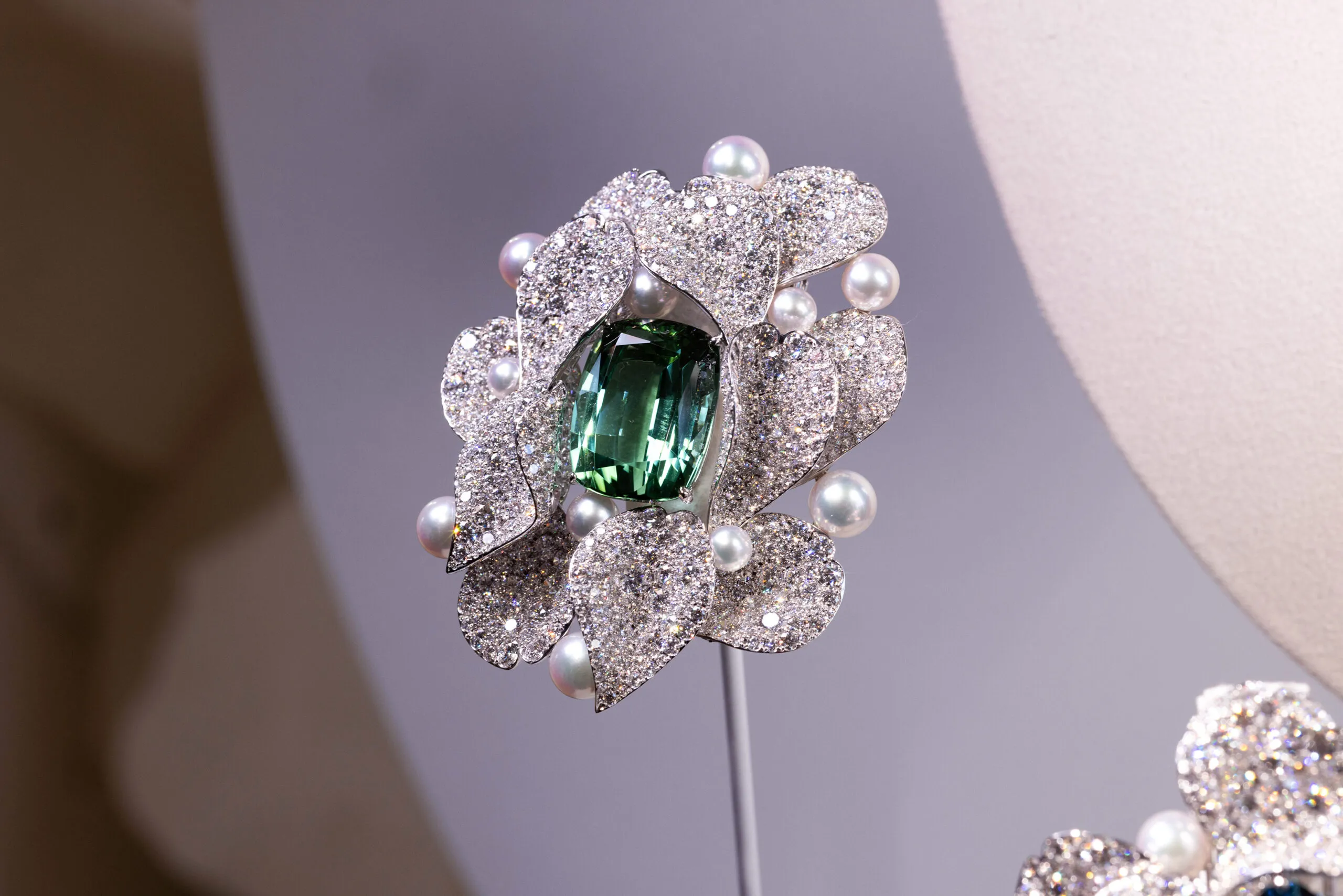An Akoya cultured pearl brooch with a 28.79-carat tourmaline and 22.71 carats of diamonds set in 18k white gold, part of the Mikimoto Les Pétales High Jewellery collection