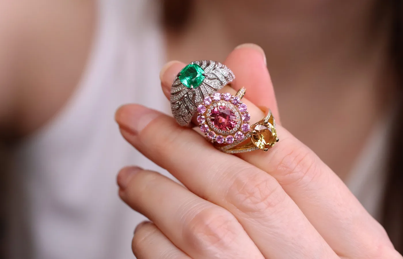  A trio of rings with Malagasy coloured gemstones by Morebelli including (from top to bottom) a 1.68 carat emerald ring set with 196 diamonds, a ring set with a 1.35 carat pink tourmaline and 1.10 carats of pink sapphires, and a 3.03 carat golden sapphire ring with diamonds