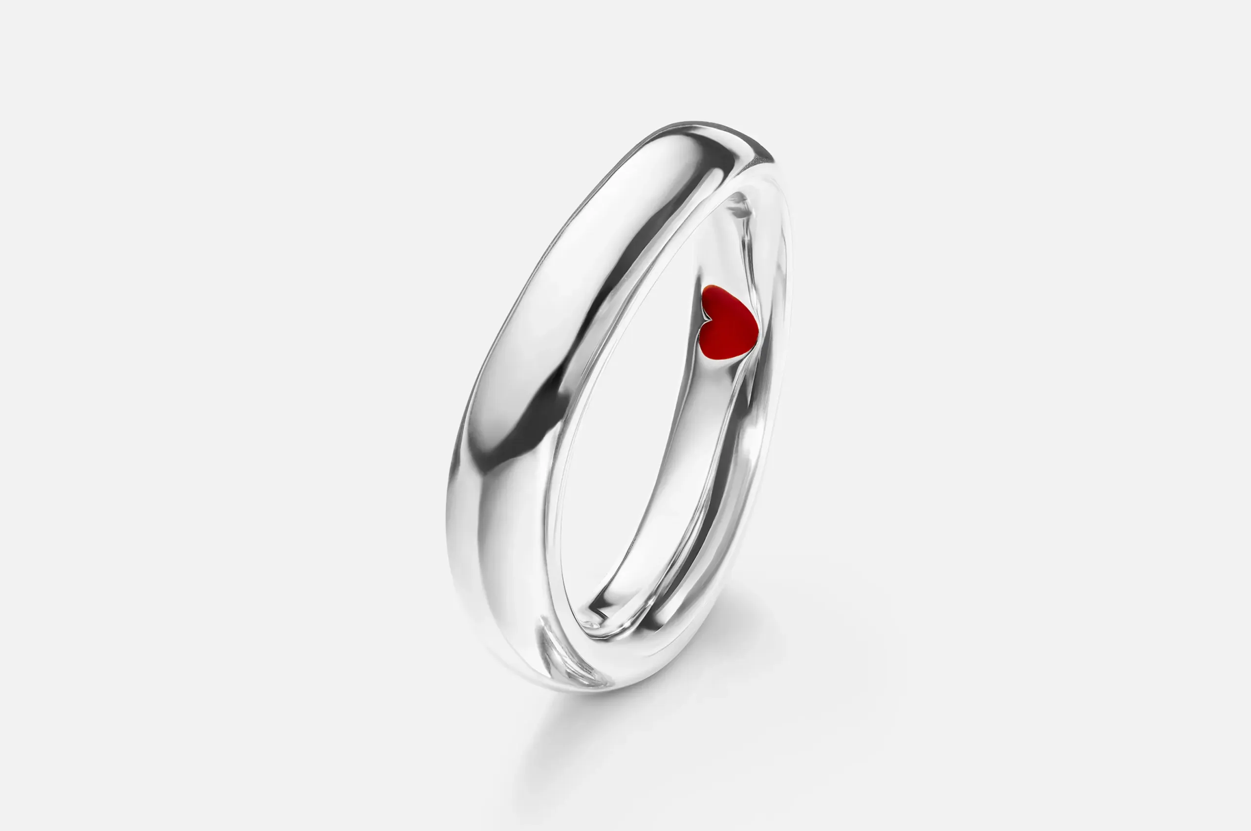 Ole Lynngard's Love ring in 18K white gold is pleasingly asymmetric, with an enamel heart concealed on the inside.