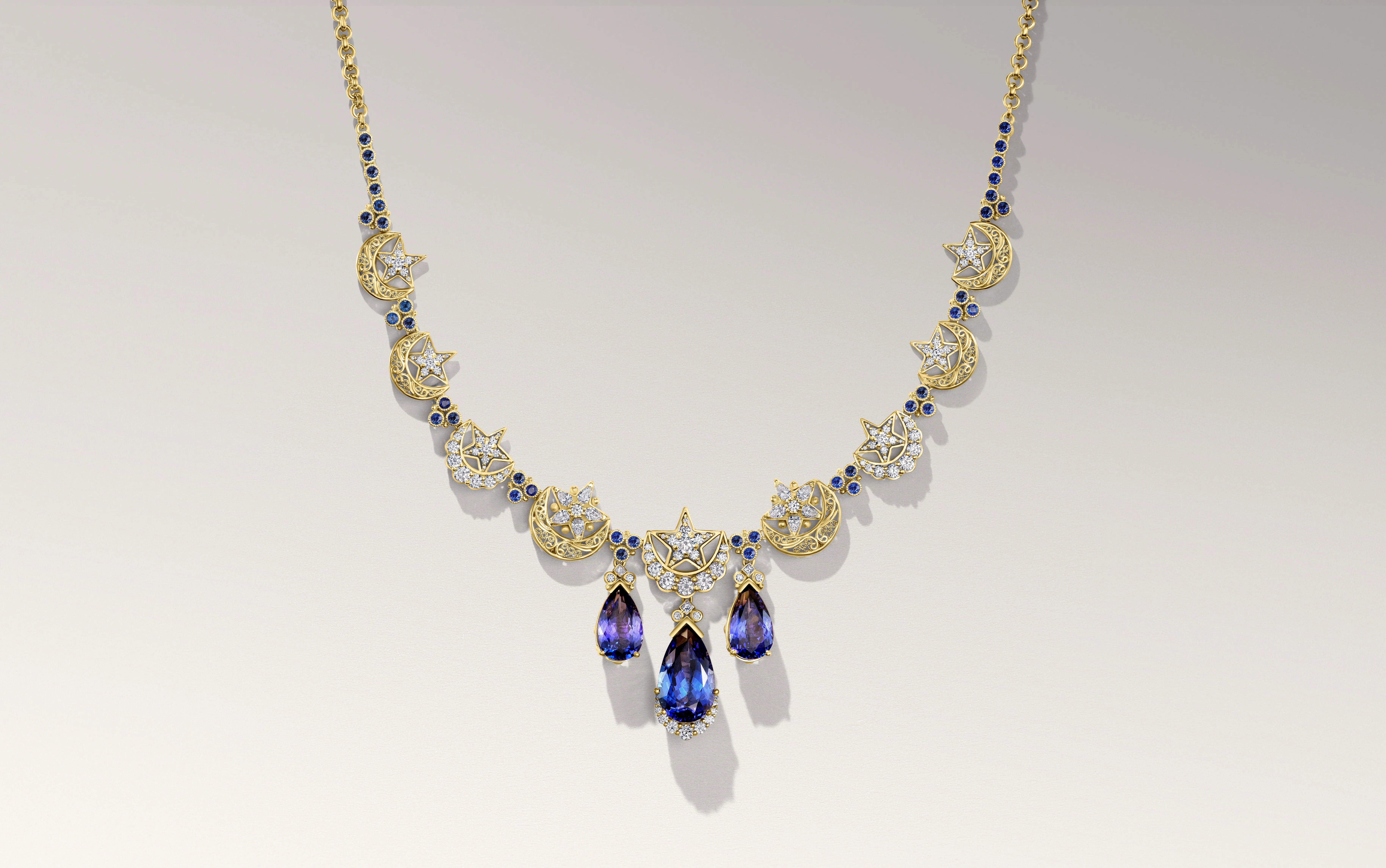 Azza Fahmy Ottoman Star & Crescent necklace from the second chapter of the Tales of the Nile High Jewellery collection with 21.63-carats of pear-shaped tanzanites, diamond-set crescent moons, filigree crescent moons and further bezel-set tanzanites