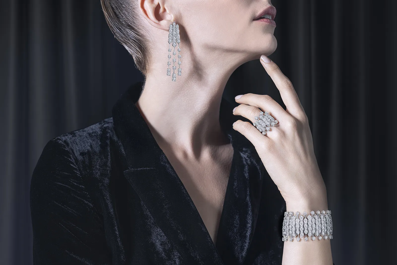 A model wears the Picchiotti Waves suite from the Picchiotti Classics collection with round brilliant-cut diamonds set in 18k white gold 