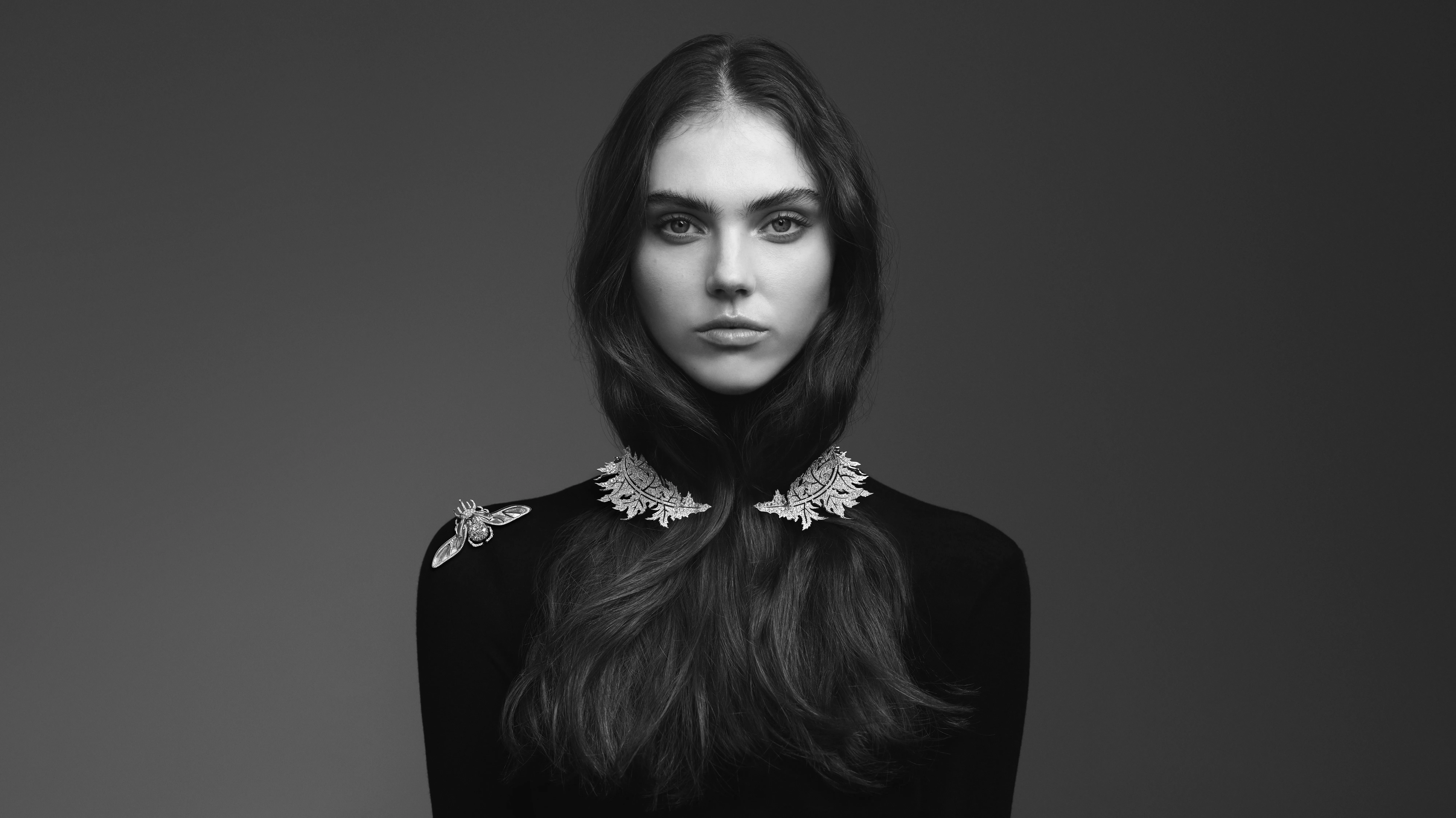 A model wears the Boucheron Scarabée Rhinocéros ring (worn as a brooch) with rock crystal, mother of pearl, black lacquer and diamonds, alongside the Chardon necklace with diamonds, both in 18k white gold, part of the Untamed Nature Histoire de Style 2025 High Jewellery collection 