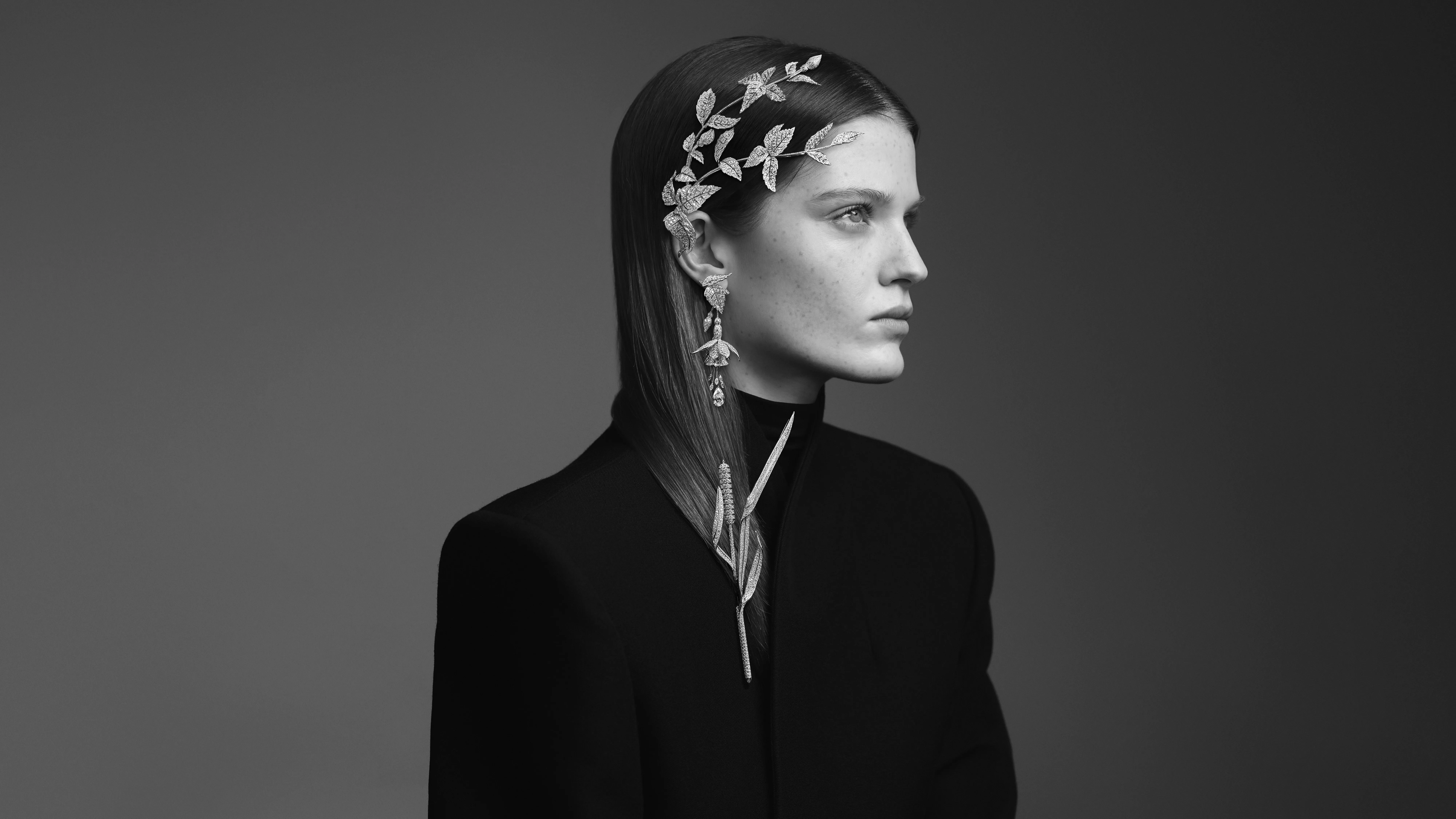 A model wears the Boucheron Fuchsia brooch, the Fuchsia pendant earrings with two D-colour, internally flawless pear-cut diamonds for a total weight of 4.10 carats, and the Roseau brooch, all with diamonds in 18k white gold, part of the Untamed Nature Histoire de Style 2025 High Jewellery collection 