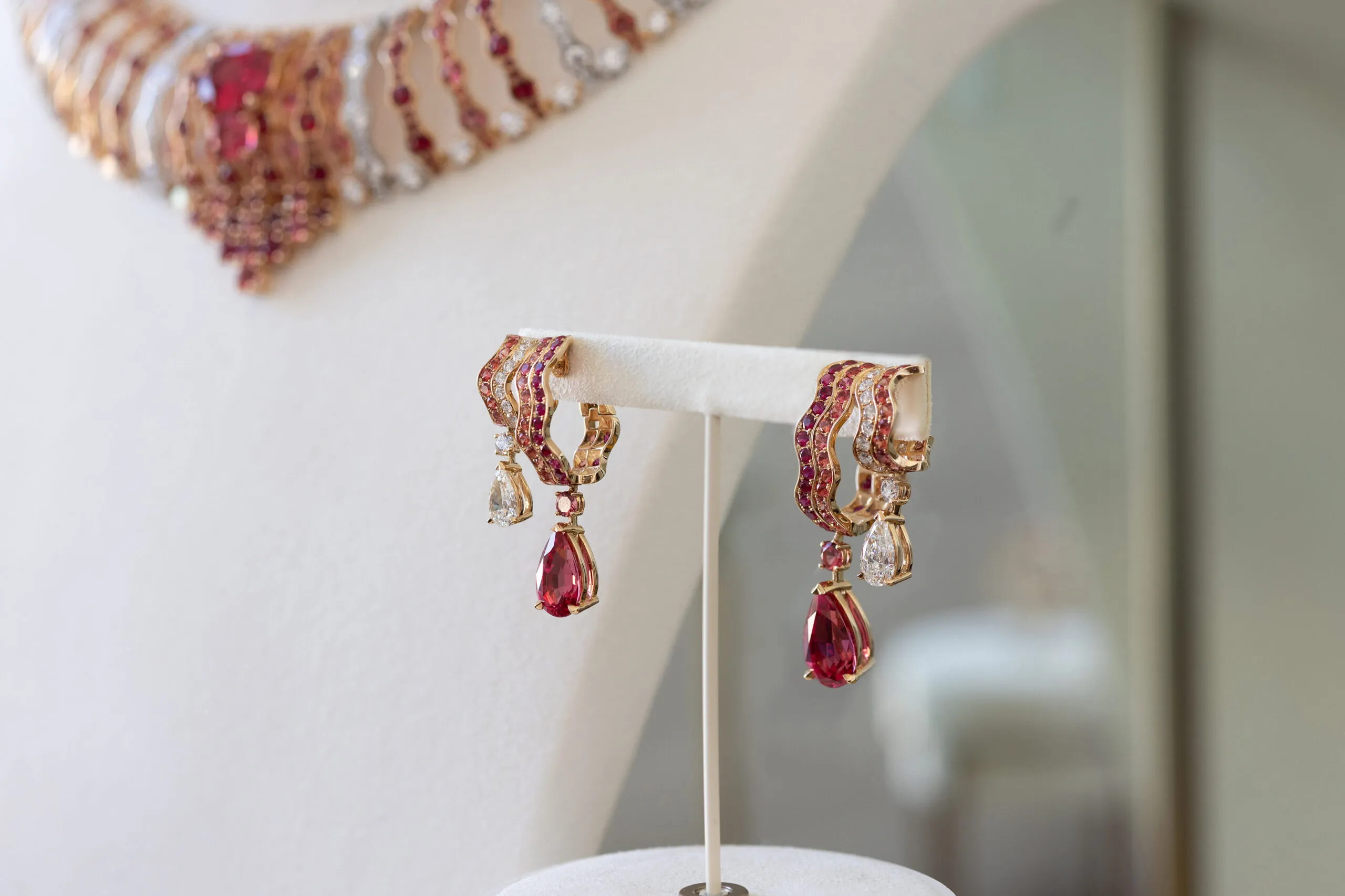 The Wave Illusion earrings, set with two pear shape red Tanzanian spinels of 4.38 and 3.79 carats, two pear shape diamonds, spinels, rubies and diamonds in 18K rose gold 