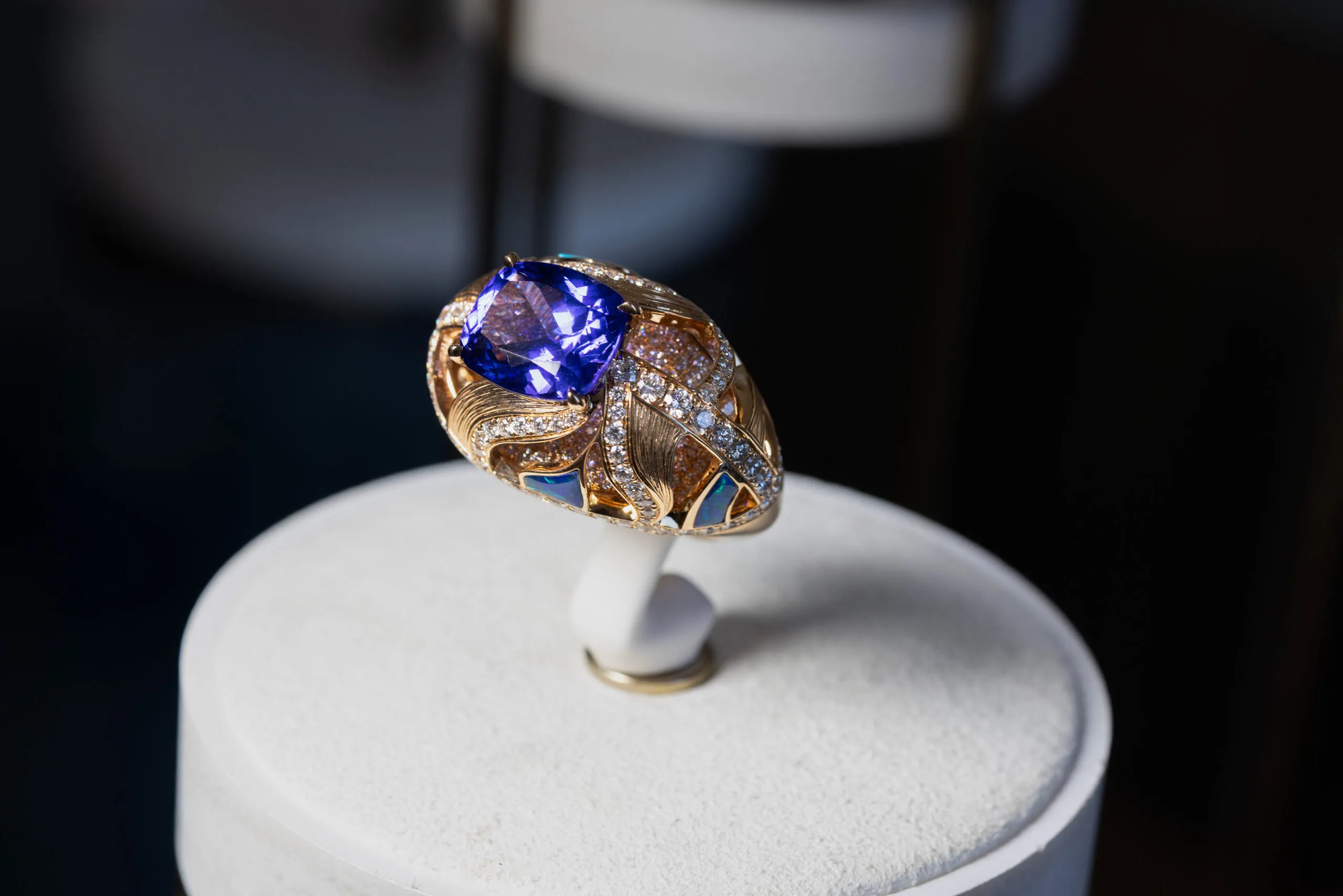 A ring completes the suite, set with a cushion cut sapphire centre stone