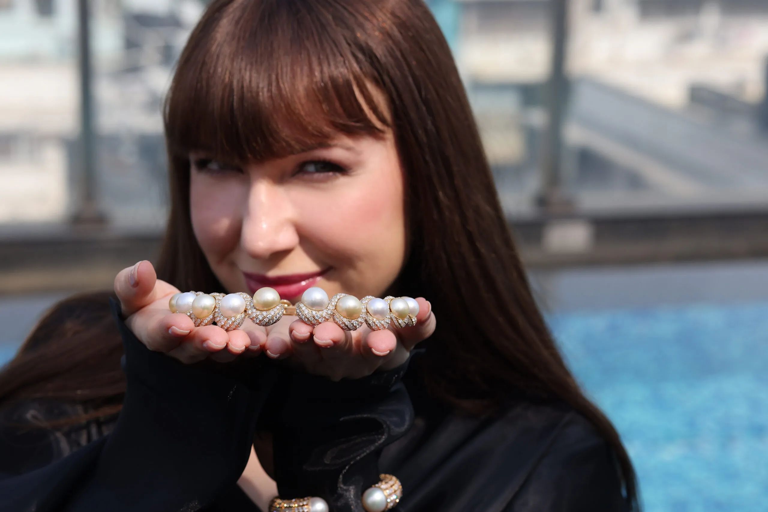 <p>Katerina Perez holds the Luminous Twin collar necklace by Renu Oberoi with 18.5 carats of diamonds and 167.3 carats of golden and white pearls</p>