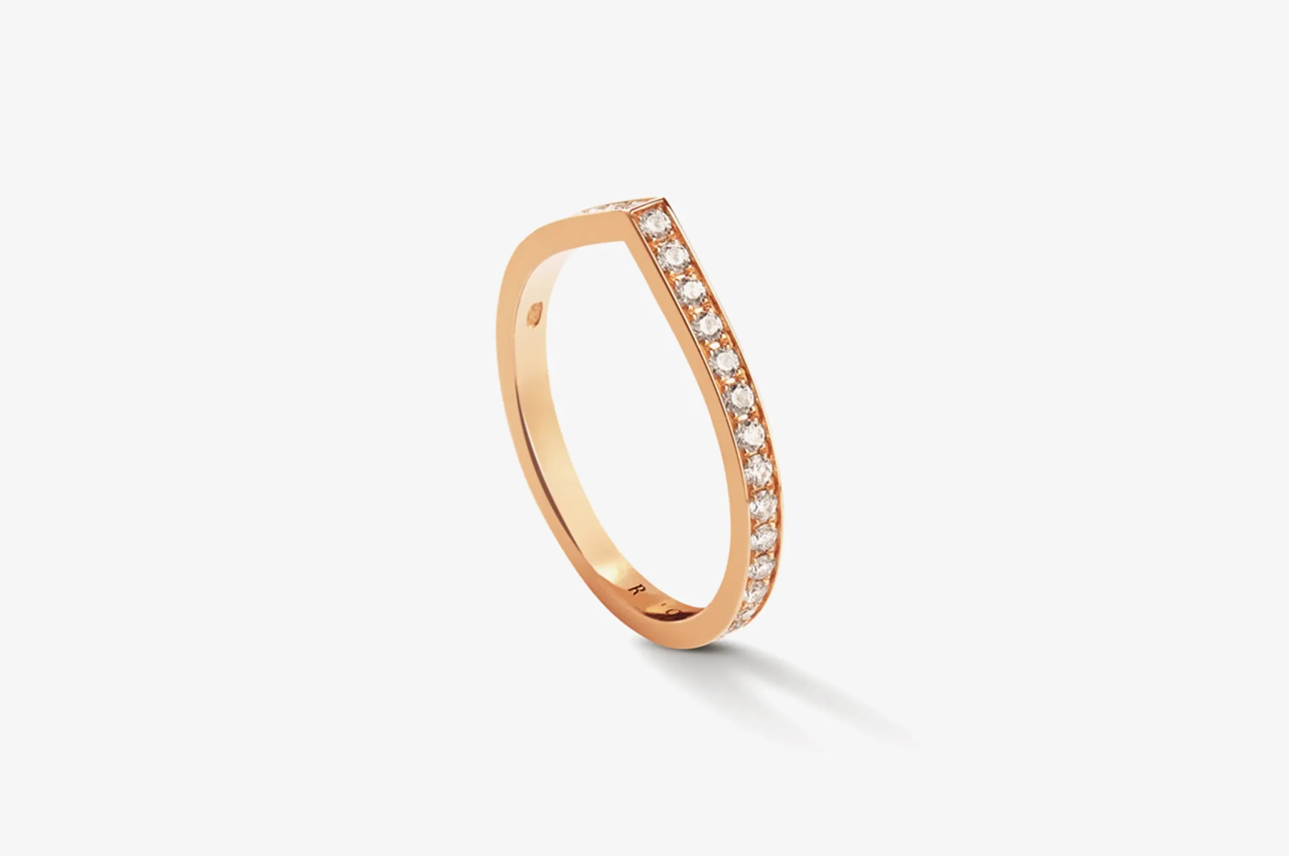 A reinvention of the wedding band, Repossi's Antifer ring in 18K yellow gold with diamonds is simple yet striking.
