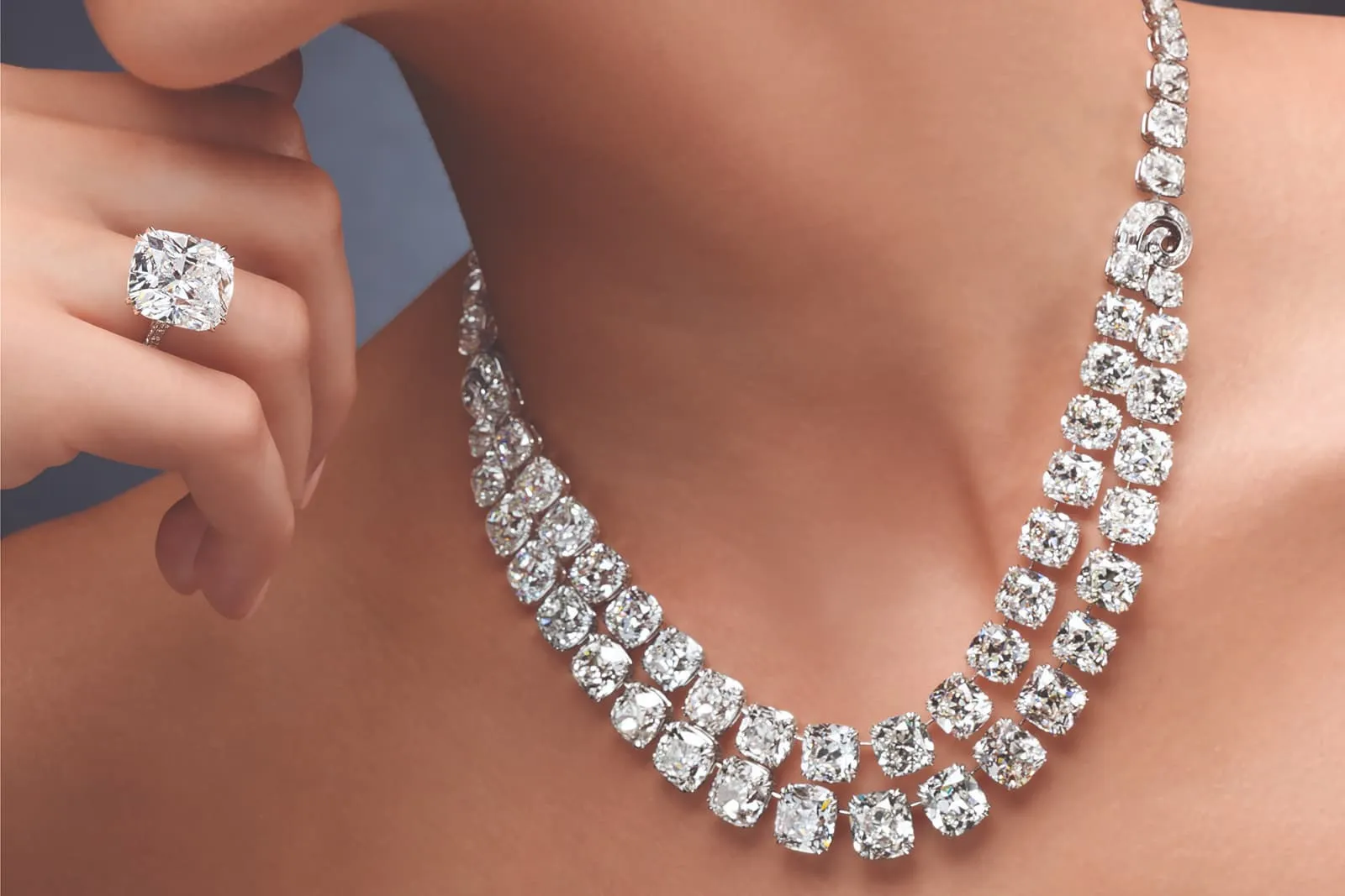 <p>Ronald Abram double row diamond necklace with 119.03 carats of antique cushion-cut diamonds alongside a 14.28 carat cushion-cut diamond ring</p>
