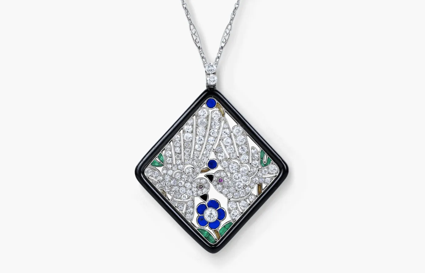 Antique Art Deco Georges Lenfant pendant featuring two doves depicted in diamonds, sapphires, emeralds and rubies. Available at Ronald Abram.