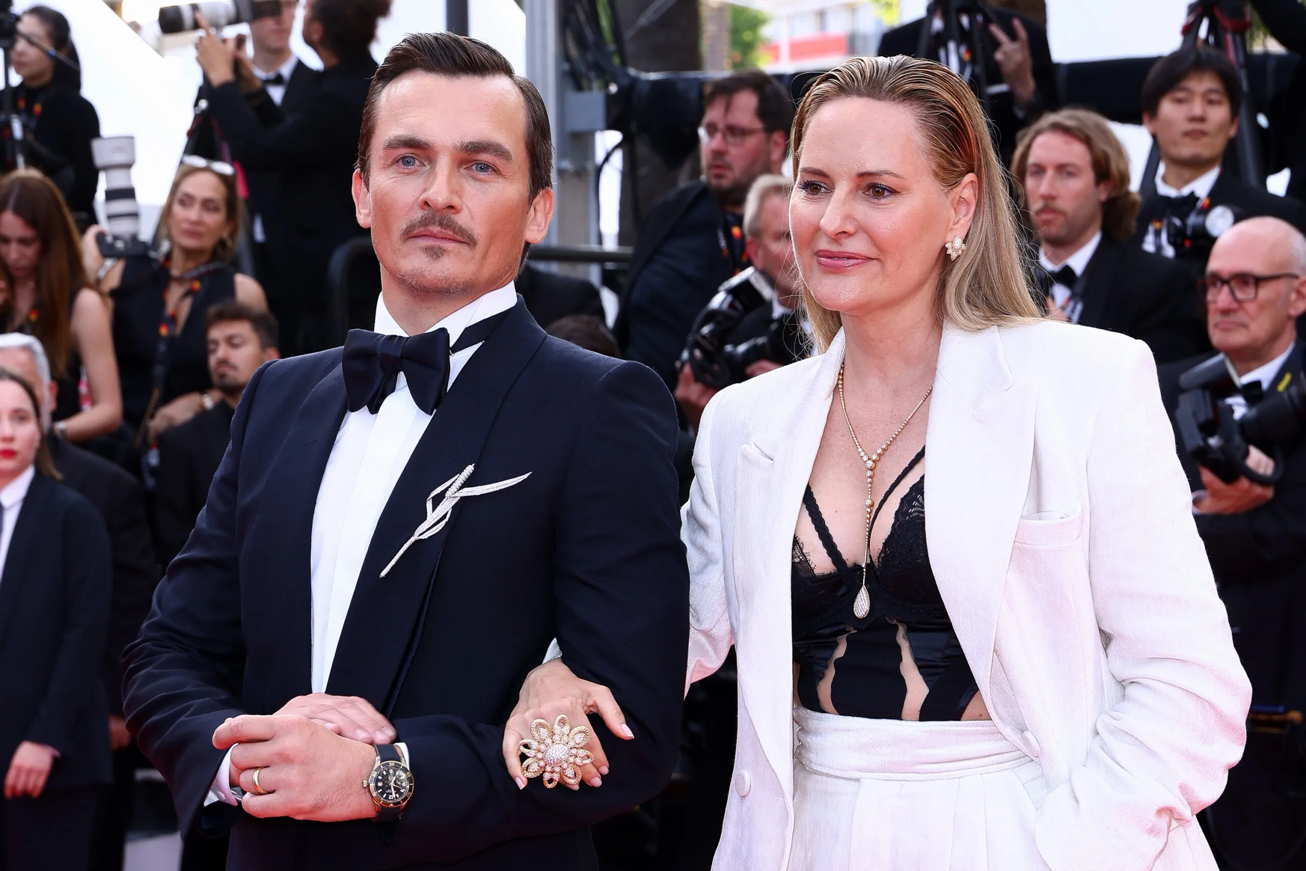 British actor Rupert Friend wears the Boucheron Roseau brooch from the Untamed Nature High Jewellery collection to the Cannes Film Festival 2025