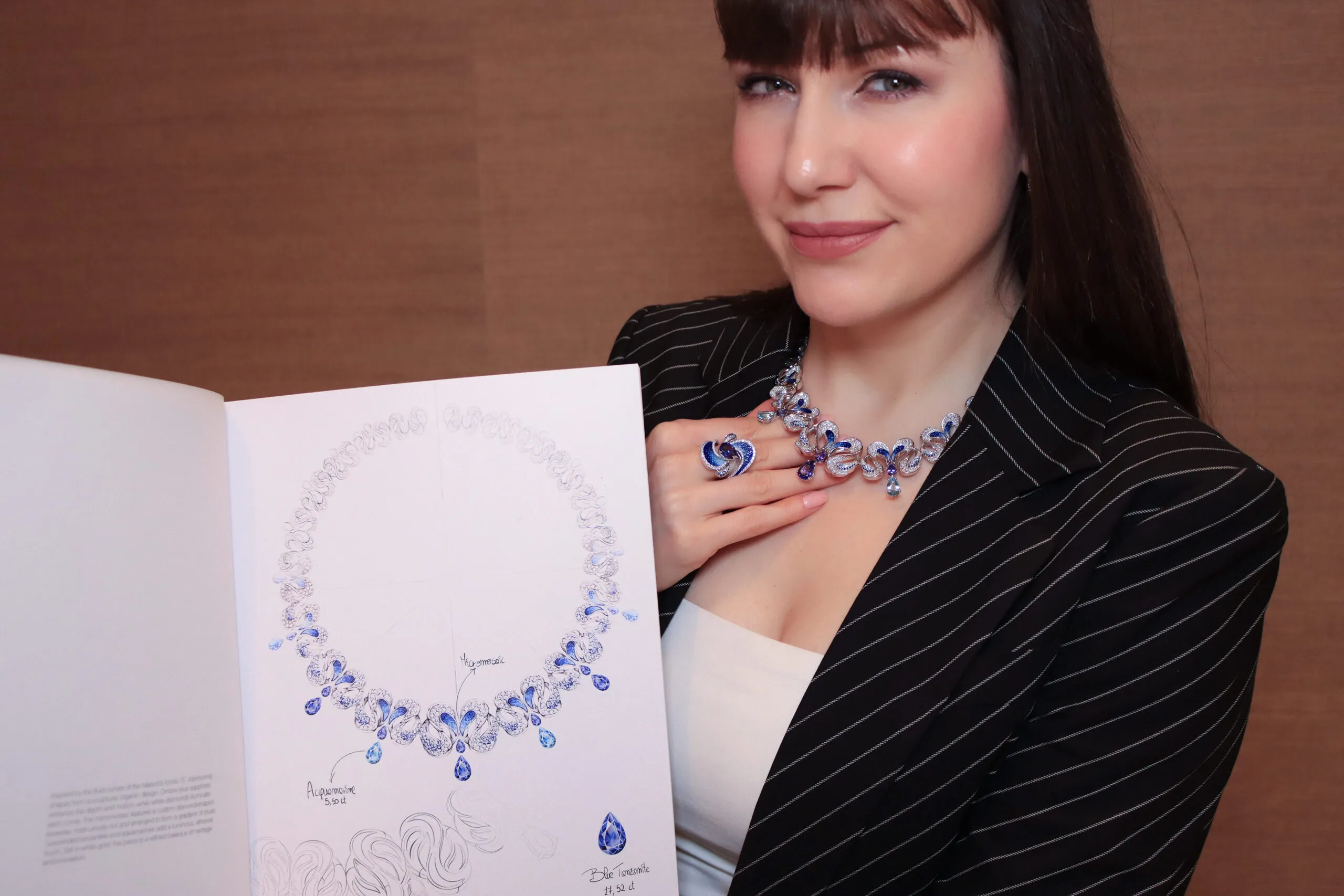 Katerina Perez wears the SICIS Icon necklace and matching ring featuring a sculptural interpretation of the letter 'S' with pear-shaped tanzanites and aquamarines, blue sapphires and micromosaics in white gold 