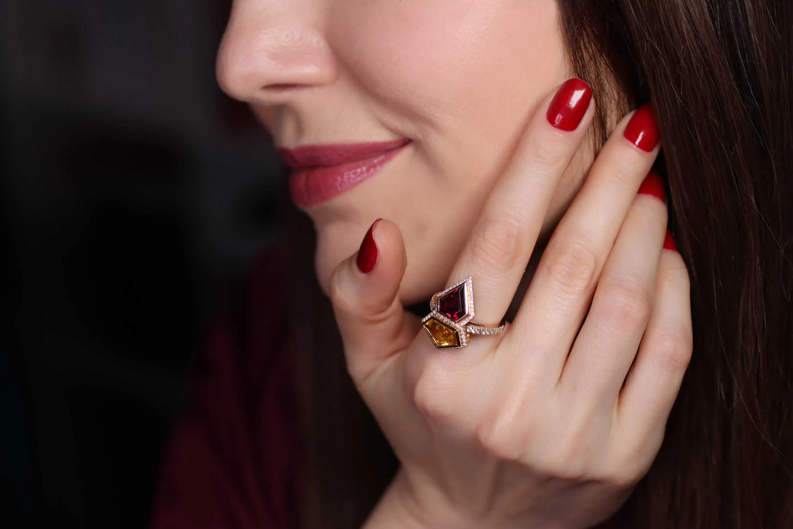 Katerina Perez wears her bespoke Superwoman ring by Sabine Roemer and Minehaus, set with a rhodolite garnet and heliodor in 18k rose gold 
