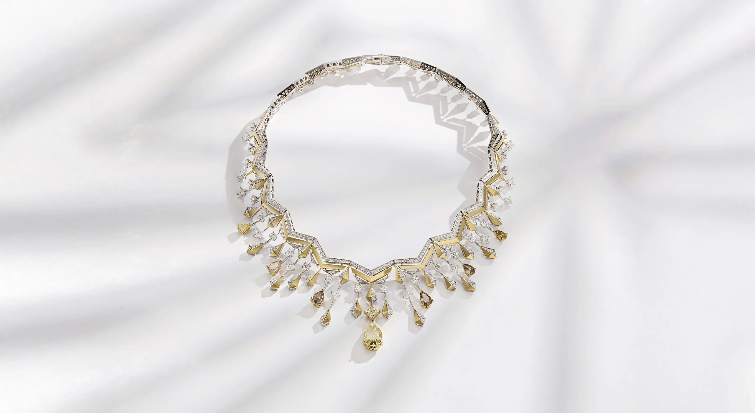Sahag Arslanian Celestial Radiance Grand Collier with a 6.35-carat pear-shaped fancy yellow VS1 diamond, surrounded by 4.76 carats of pear-shaped yellow-brown diamonds, cushion-cut fancy colour diamonds, 2.78 carats of princess-cut white diamonds, 8.53 carats of round white diamonds and 11.36 carats of further melee diamonds, set in 18k white and yellow gold 
