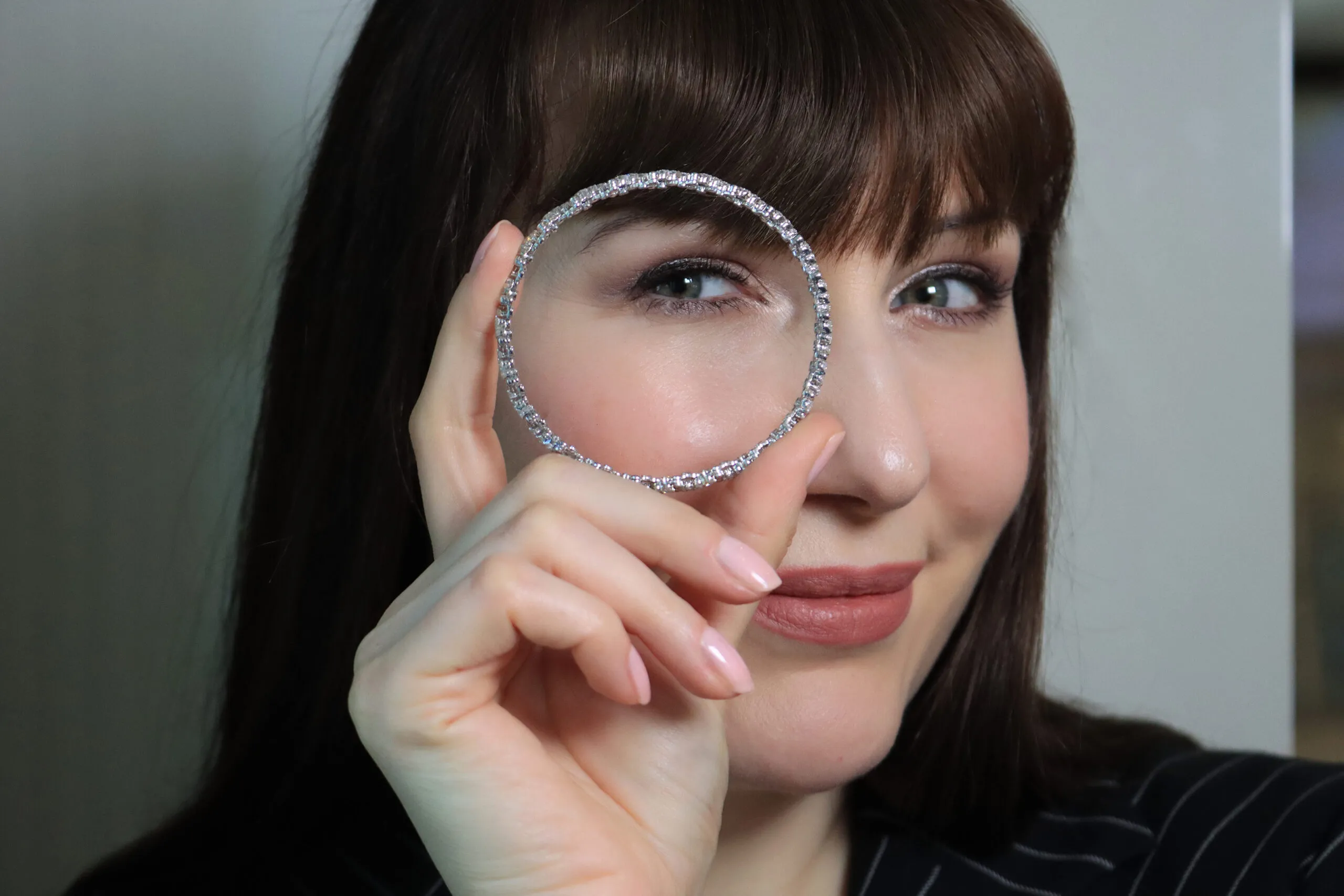 Katerina Perez holds a Serafino collection bracelet, which can contract to be worn as a diamond-set ring