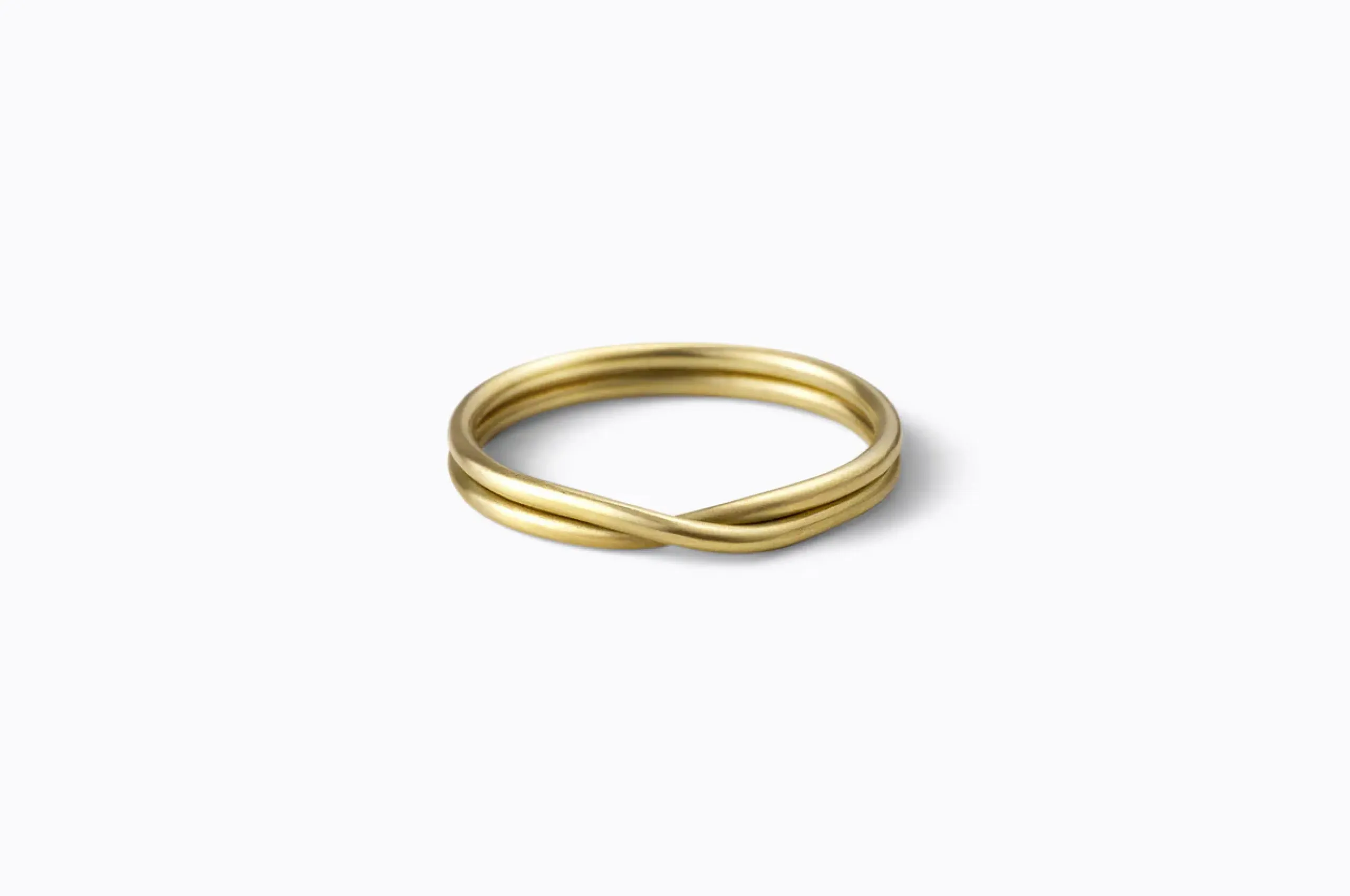 Simple and stylish, Shiara's double ring twisted strands of 18K yellow gold together to form a delicate knot.