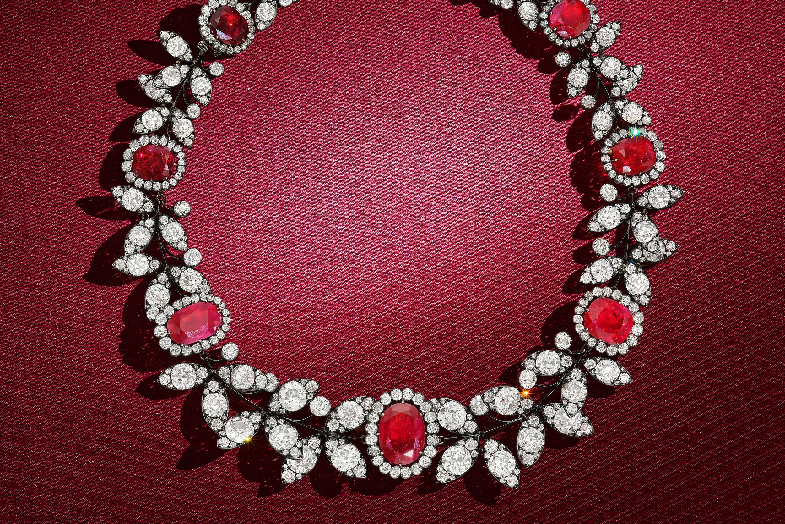 <p>Close-up of a Boucheron ruby and diamond necklace featuring cushion-cut rubies and old mine and old European–cut diamonds</p>
