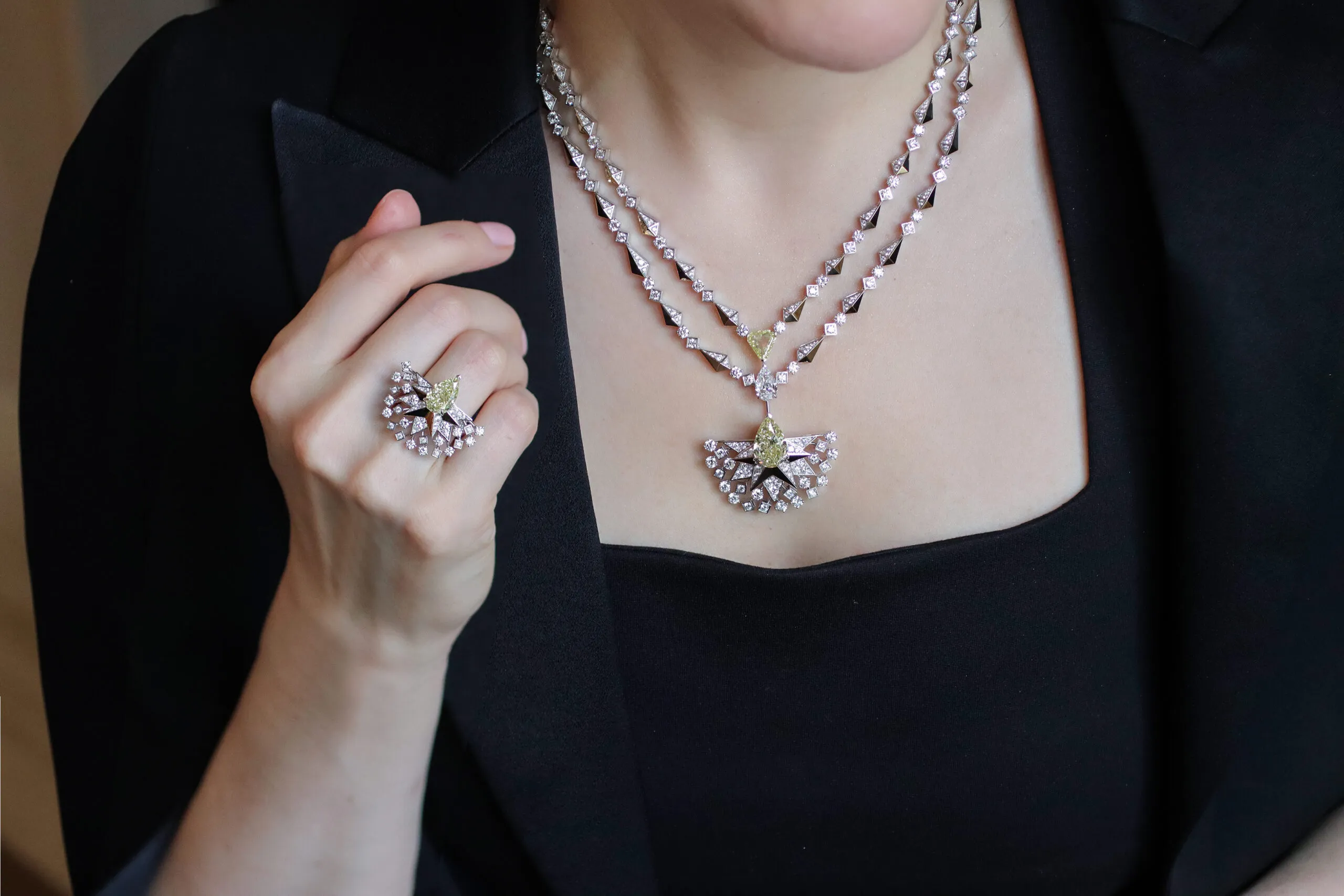 Katerina Perez wears the Sahag Arslanian Sun Rays High Jewellery necklace with an 8.88-carat pear-shaped fancy yellow VS2 diamond, a 2.03-carat triangular-shaped fancy intense yellow SI1 diamond, and a 2.01-carat pear-shaped E-colour, VS1 diamond, surrounded by 17.04 carats of round white diamonds, set in 18k white and yellow gold, alongside the Sun Rays High Jewellery ring with a 3.38-carat pear-shaped fancy yellow VS2 diamond and round white diamonds, also in 18k gold 