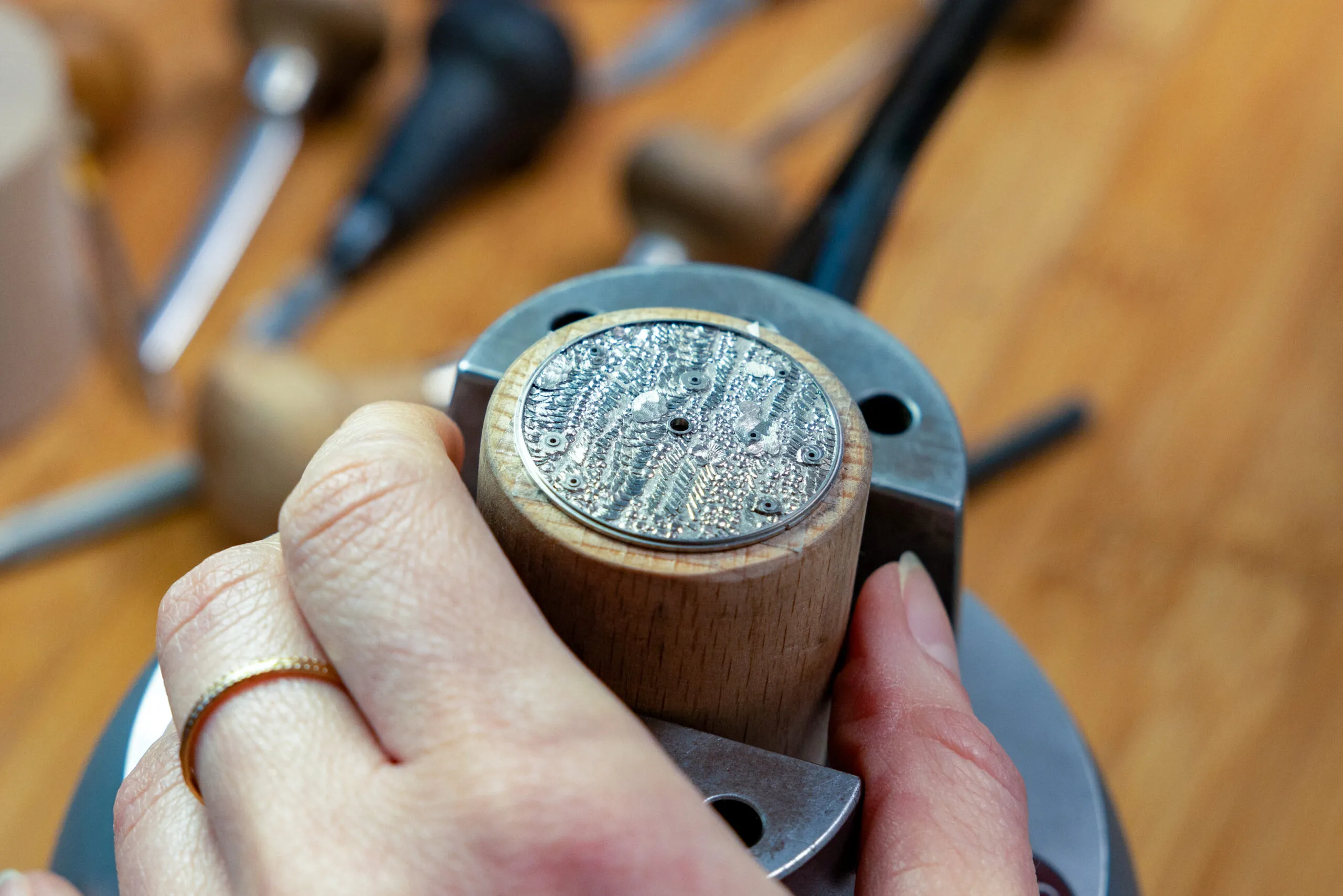 The raised hand-engraved dial that forms the backdrop for the TAOS Sequins watch 