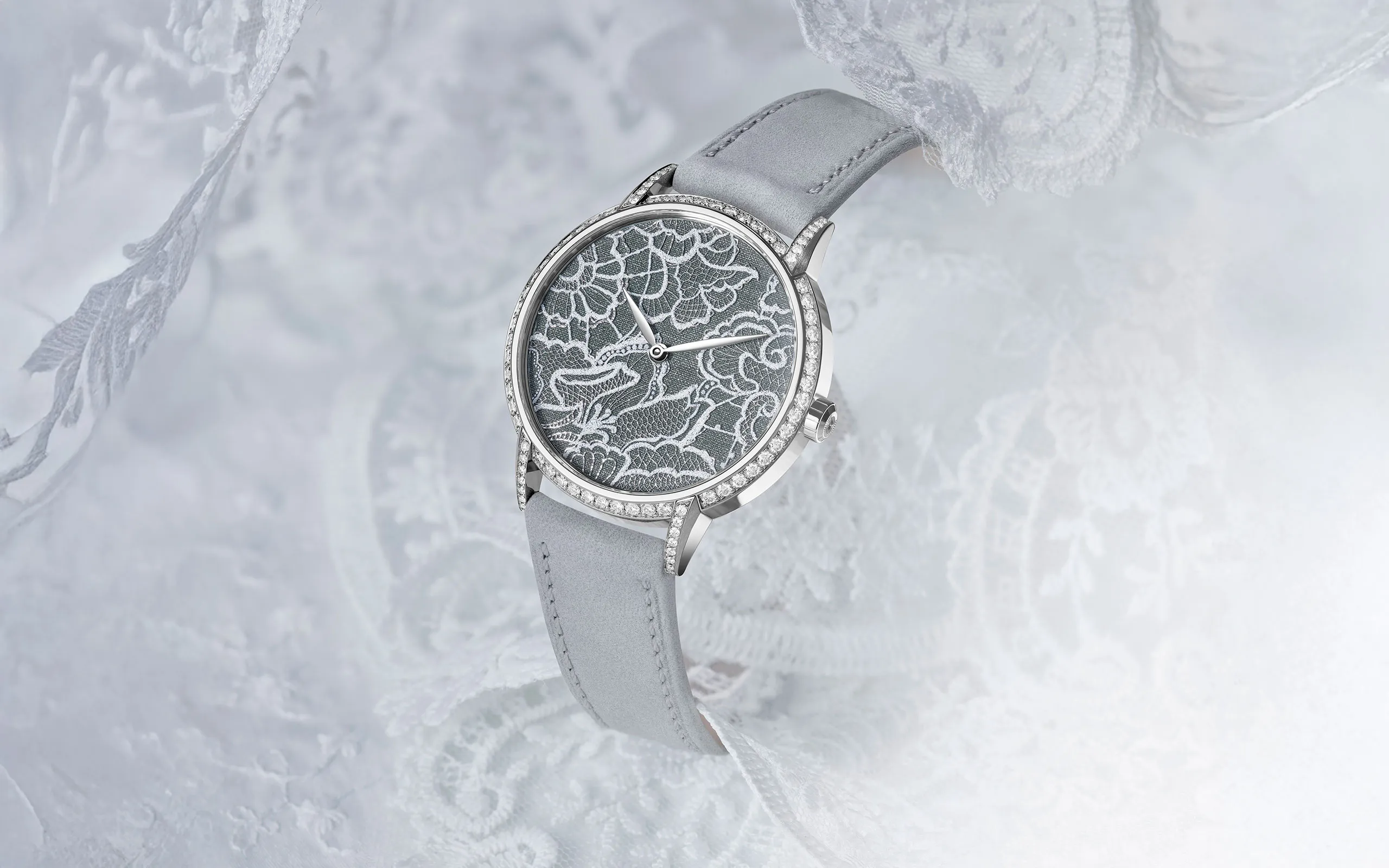 TAOS Dentelle timepiece inspired by Swiss lace with hand-engraving, enamel and a fine silver paillon mesh to recreate the texture of fabric 