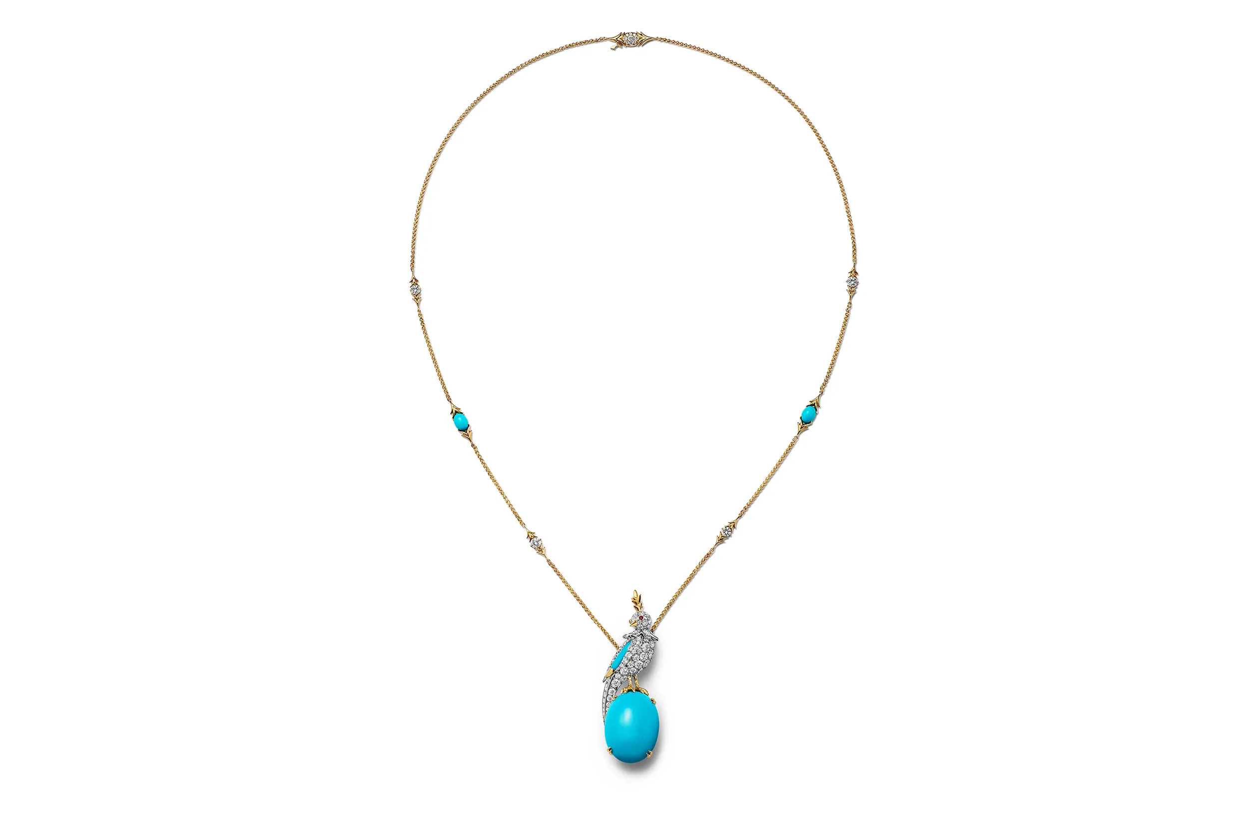 <p>Tiffany &amp; Co. Bird on a Rock pendant in 18k yellow gold and platinum, with a cabochon turquoise over 16 carats, diamonds and a ruby</p>
