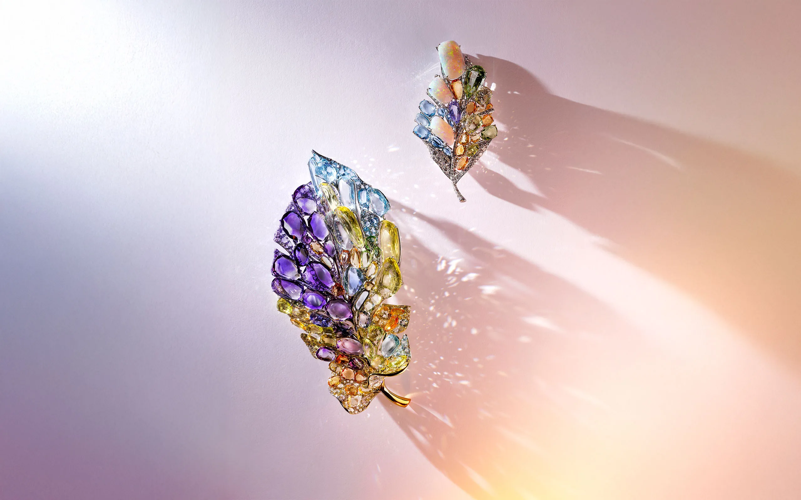 Two pieces by Feng J to be presented at TEFAF Maastricht 2025, including the Toi et moi brooch (left) with opal, double rose-cut tourmalines, aquamarines, chrysoberyls, sapphires, spinels, tsavorites, quartz and diamonds 