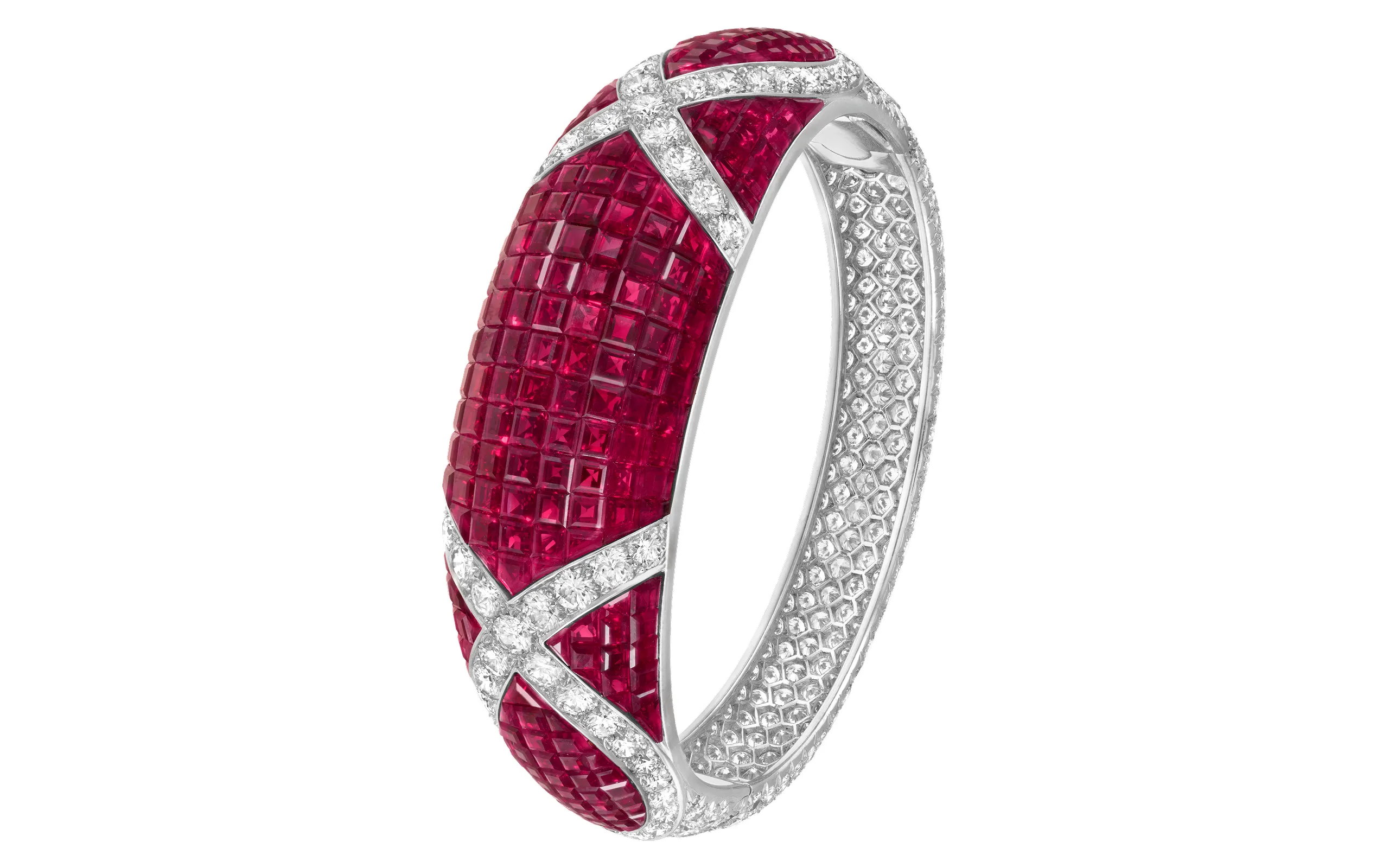 Contrasting Mystery Set rubies with brilliant cut diamonds, the technique makes it possible to create surfaces of captivating chromatic depth