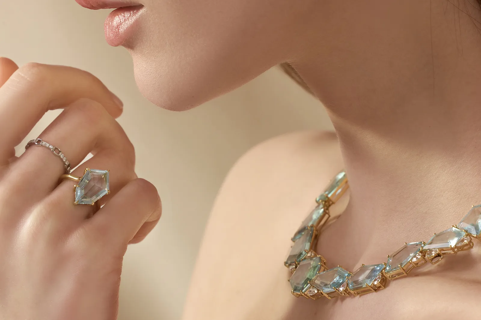 A model wears the Contour Polygon ring by Yi Collection, set with a 5.51 carat aquamarine and diamonds in 18k yellow gold 