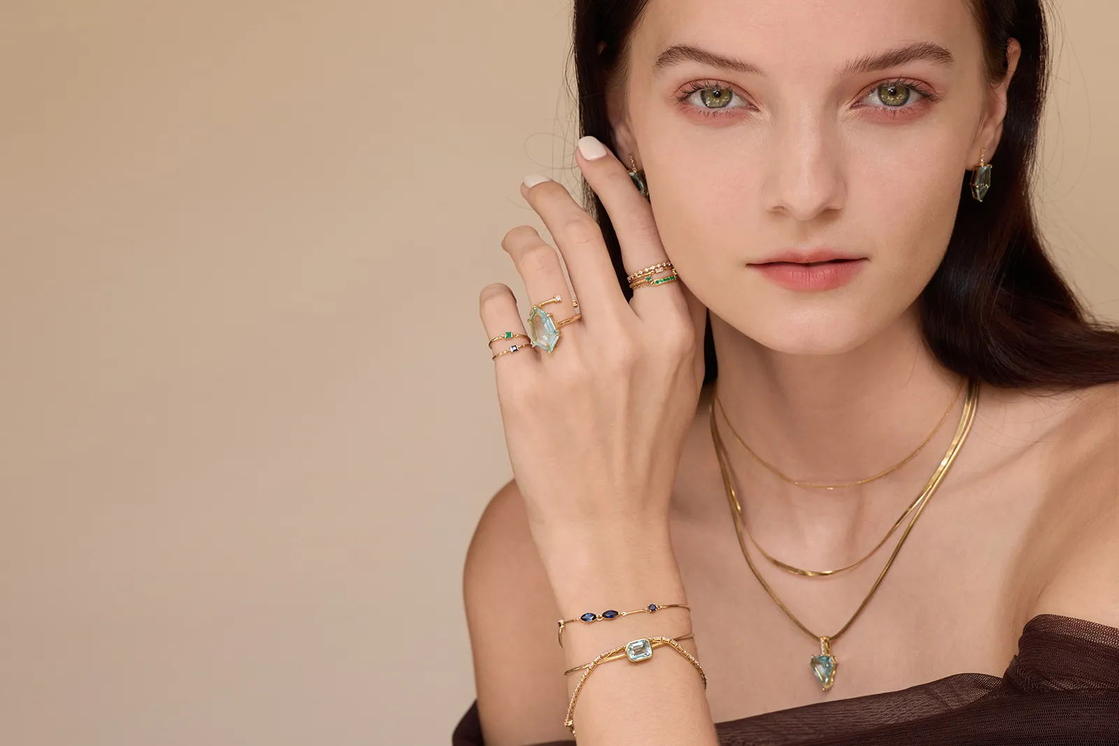 A model wears a selection of pieces by Yi Collection, including aquamarines from the new Contour collection 
