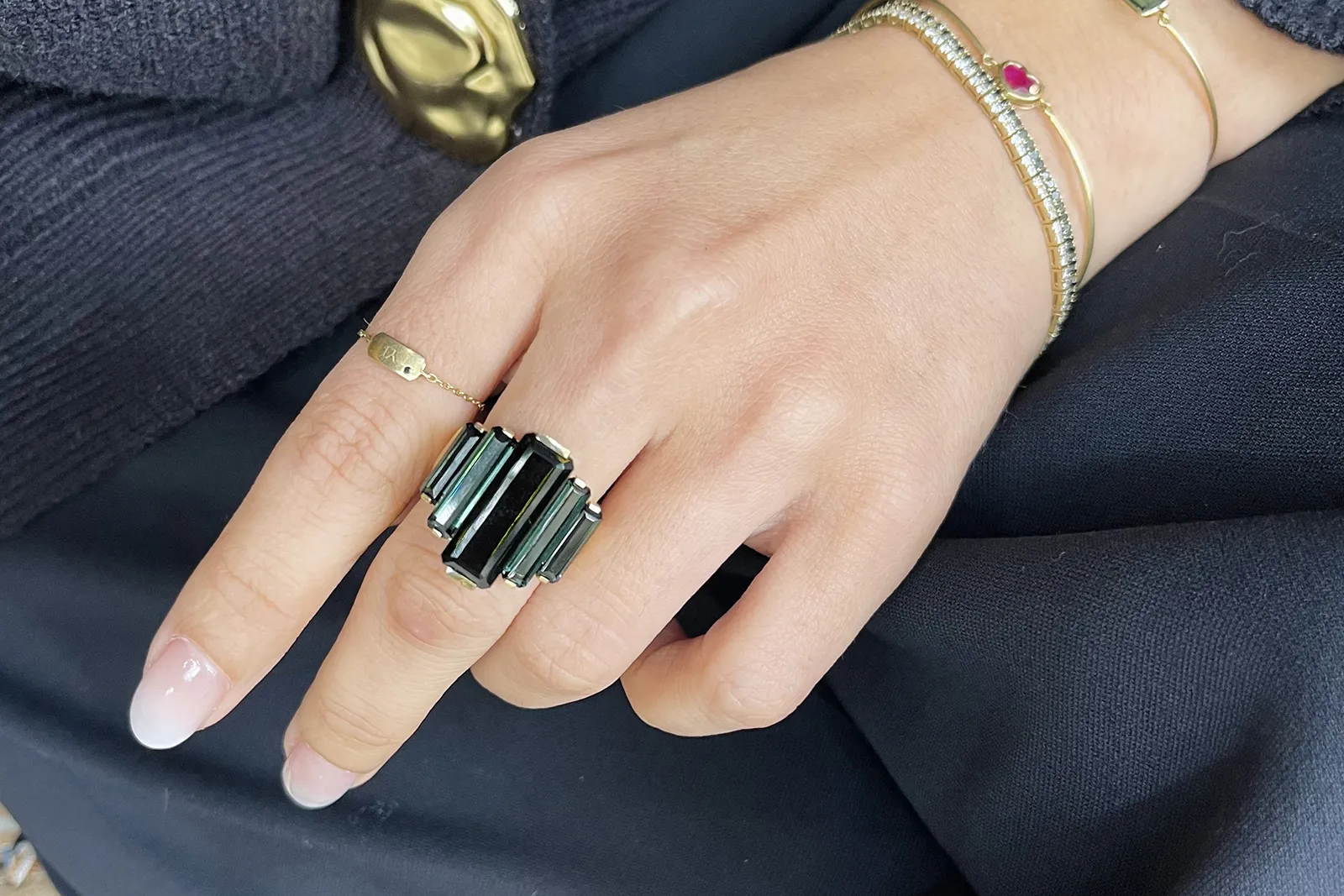 Yi Collection Tourmaline Rhythm Supreme ring with a central black tourmaline surrounded by two pairs of blue tourmalines, totalling 12.725 carats, set in 18k yellow gold 