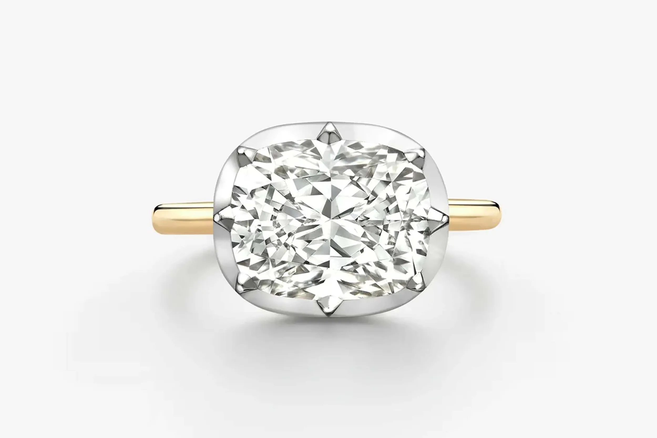 <p>Jessica McCormack 5.02 carat east-west cushion cut diamond button back ring in 18K white and yellow gold.</p>
