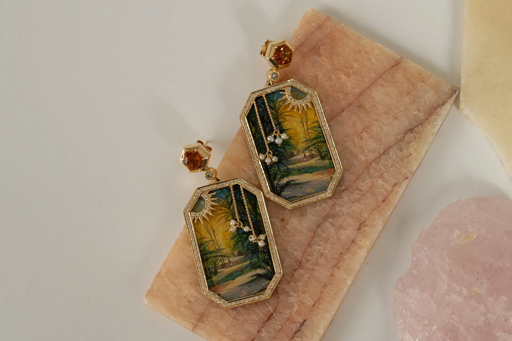 Kyan Jewelry Whispers of the Oasis earrings in collaboration with Bahraini artist Abbas Almosawi with orange garnets, champagne diamonds and natural Bahrain pearls surrounding a hand-painted artwork in 18k gold 
