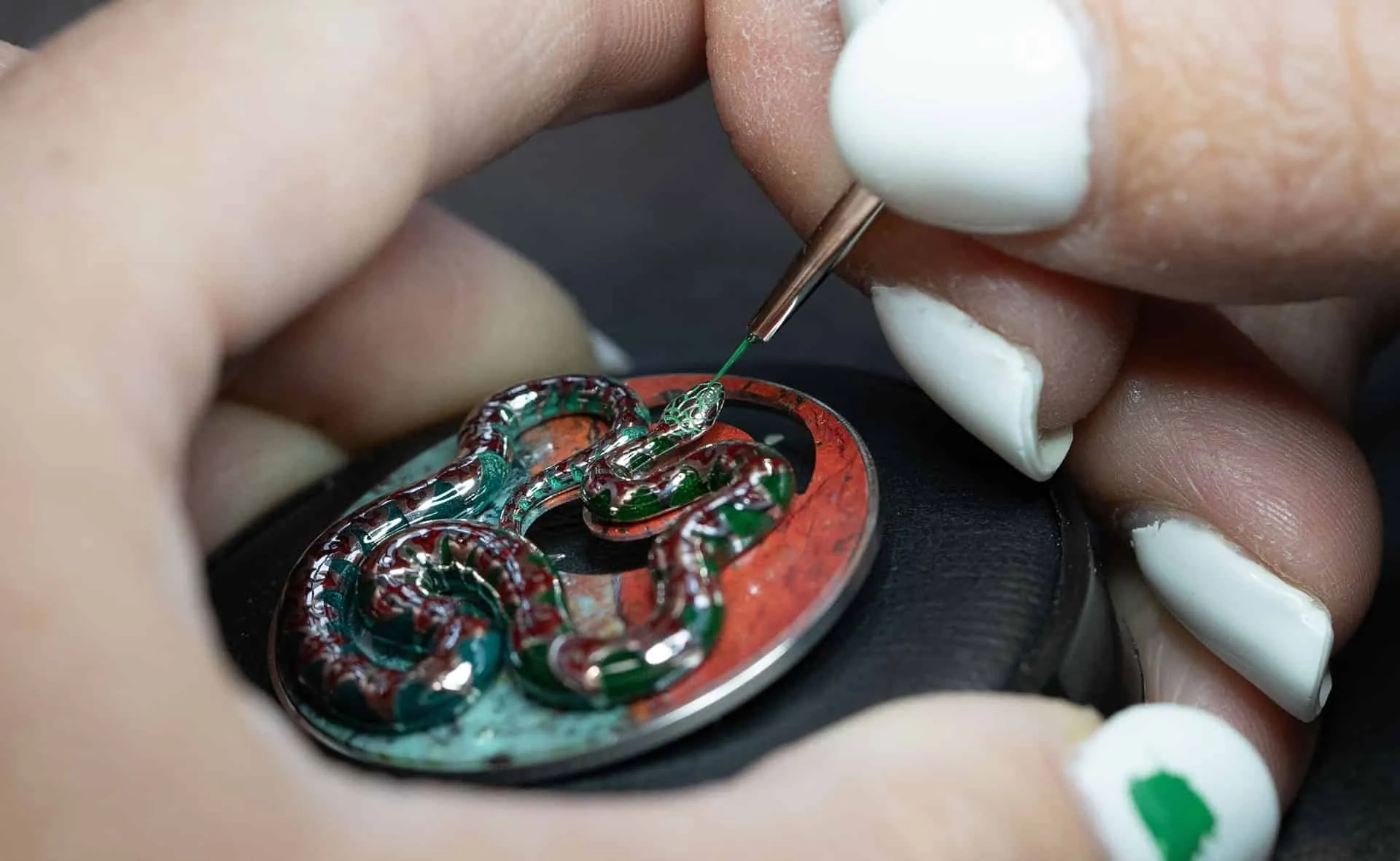 Hand painting enamel details on the Jaquet Droz Ophidian Hour watch with a Sonora Sunrise (chrysocolla cuprite) dial