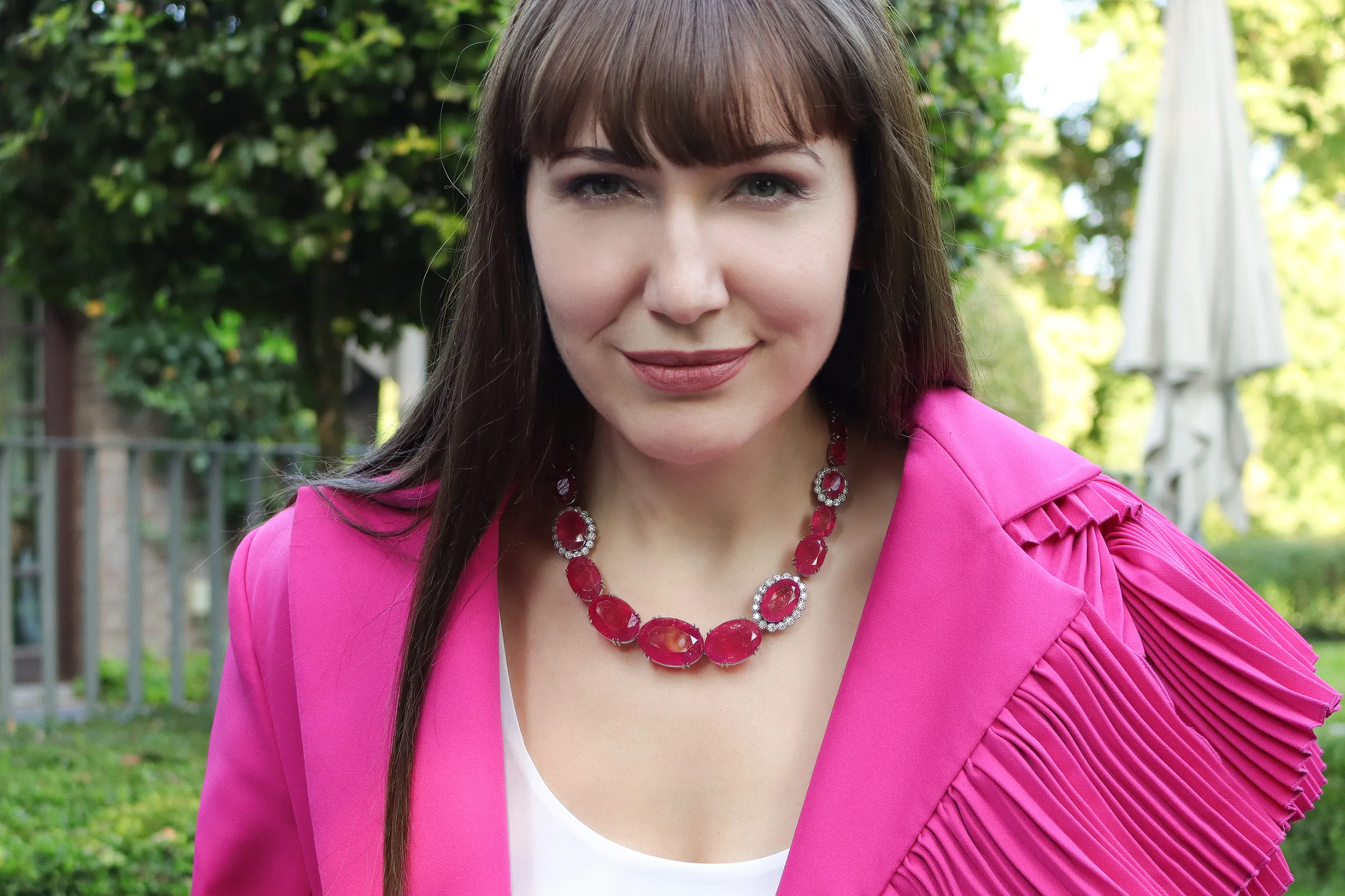 <p>Katerina wears an incredibly rare Pezzottaite and diamond necklace by Jochen Leën</p>