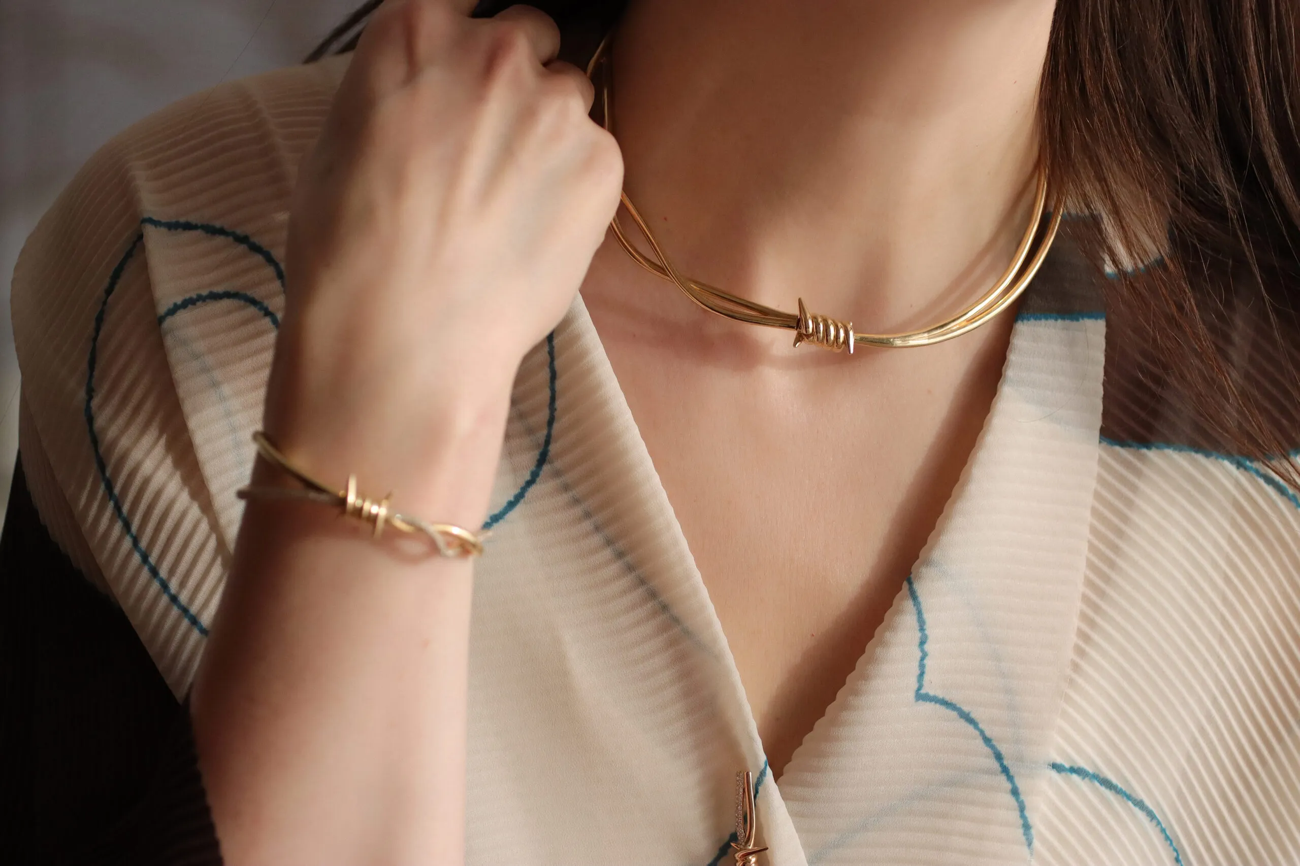 <p>The barbed wire motifs are both beautiful and unsettling with their sharpness, softened by the sculptural elegance of the jewels</p>
