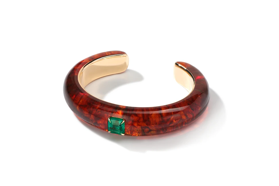 <p>The Amber Room cuff bracelet by Liza Borzaya with a claw-set emerald in a piece of carved amber, set in 18k yellow gold </p>

