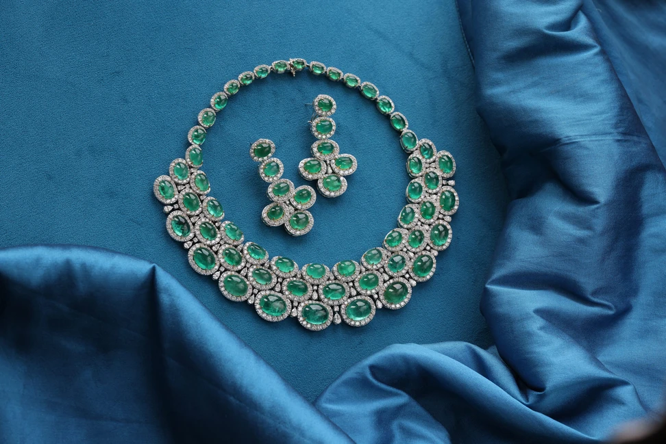 <p>The Renu Oberoi Nizam Jade collar necklace set with 183.6 carats of Zambian emerald cabochons and 36 carats of diamonds, shown here alongside the matching Emerald Axis earrings with 35.39 carats of emeralds and a further nine carats of diamonds</p>