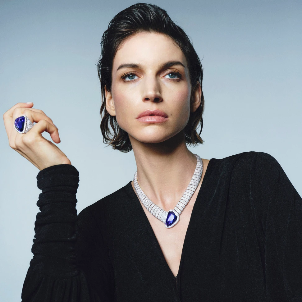 <p>A model wears the Pomellato Asimmetrico Tanzanite necklace with an irregularly cut 55.96-carat tanzanite and the matching ring with a 37.73-carat tanzanite, part of the &#8216;Collezione 1967&#8217; High Jewellery collection</p>
