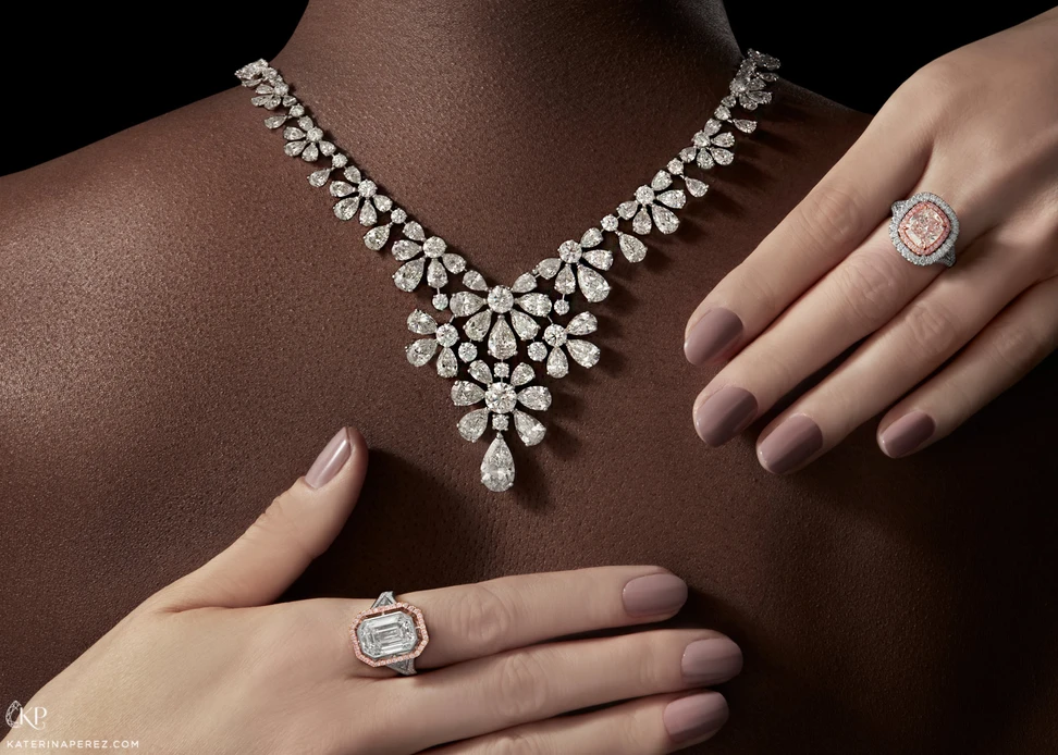 <p>Left to right: Calleija hand crafted ring with 5.06ct emerald cut diamond in platinum and 18k rose gold, David Morris ‘Gardenia’ necklace with pear cut and brilliant diamonds in 18k white gold, Calleija ‘Millenia’ 2.43ct cushion cut light pink diamond, with Argyle pink diamonds and colourless diamond halos in platinum and 18k rose gold</p>