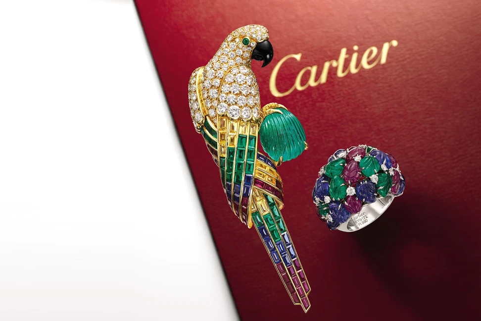 <p>Cartier Tutti Frutti inspired parrot brooch and carved gemstone ring sold by Sotheby&#8217;s</p>
