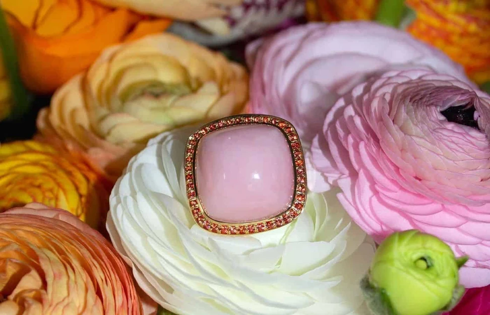 <p>Charlotte Reedtz Jewellery Magic Wish ring in 18k yellow gold with a pink opal cabochon and orange sapphire halo</p>
